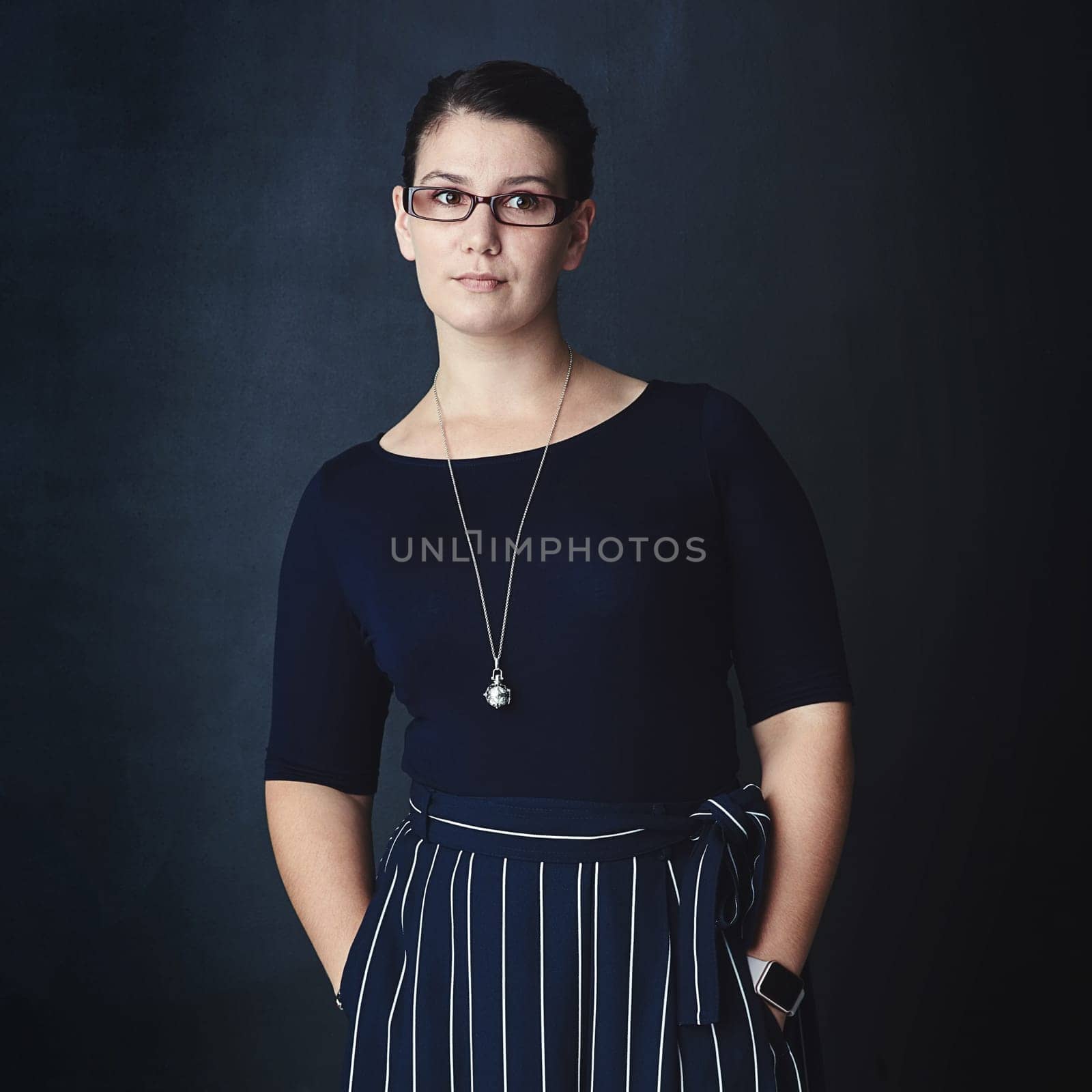 Let your vision be your driving force towards success. Studio shot of a corporate businesswoman looking thoughtful against a dark background. by YuriArcurs
