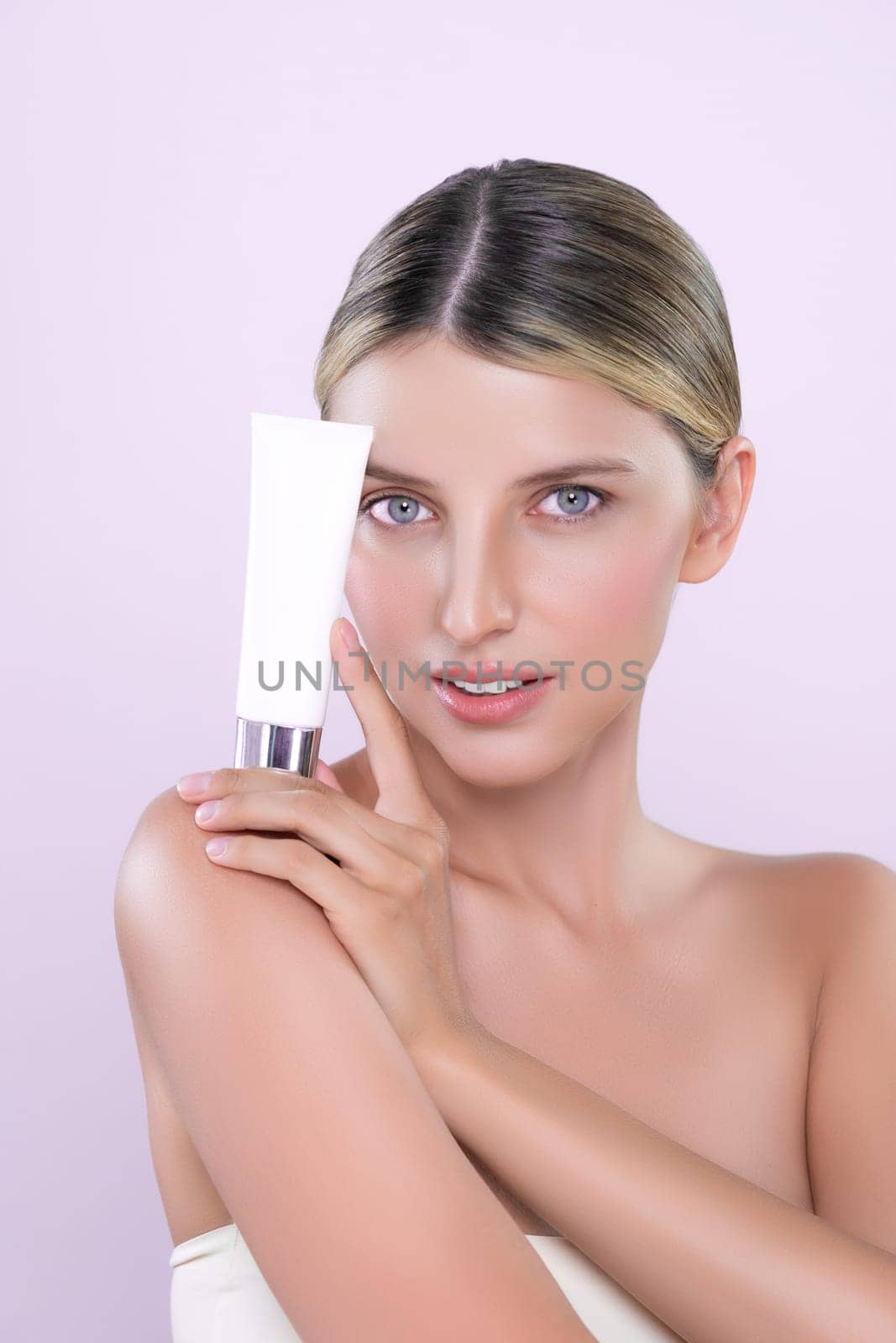 Alluring beautiful perfect cosmetic skin woman portrait hold mockup tube cream or moisturizer for skincare treatment, anti-aging product in isolated background. Natural healthy skin model concept.