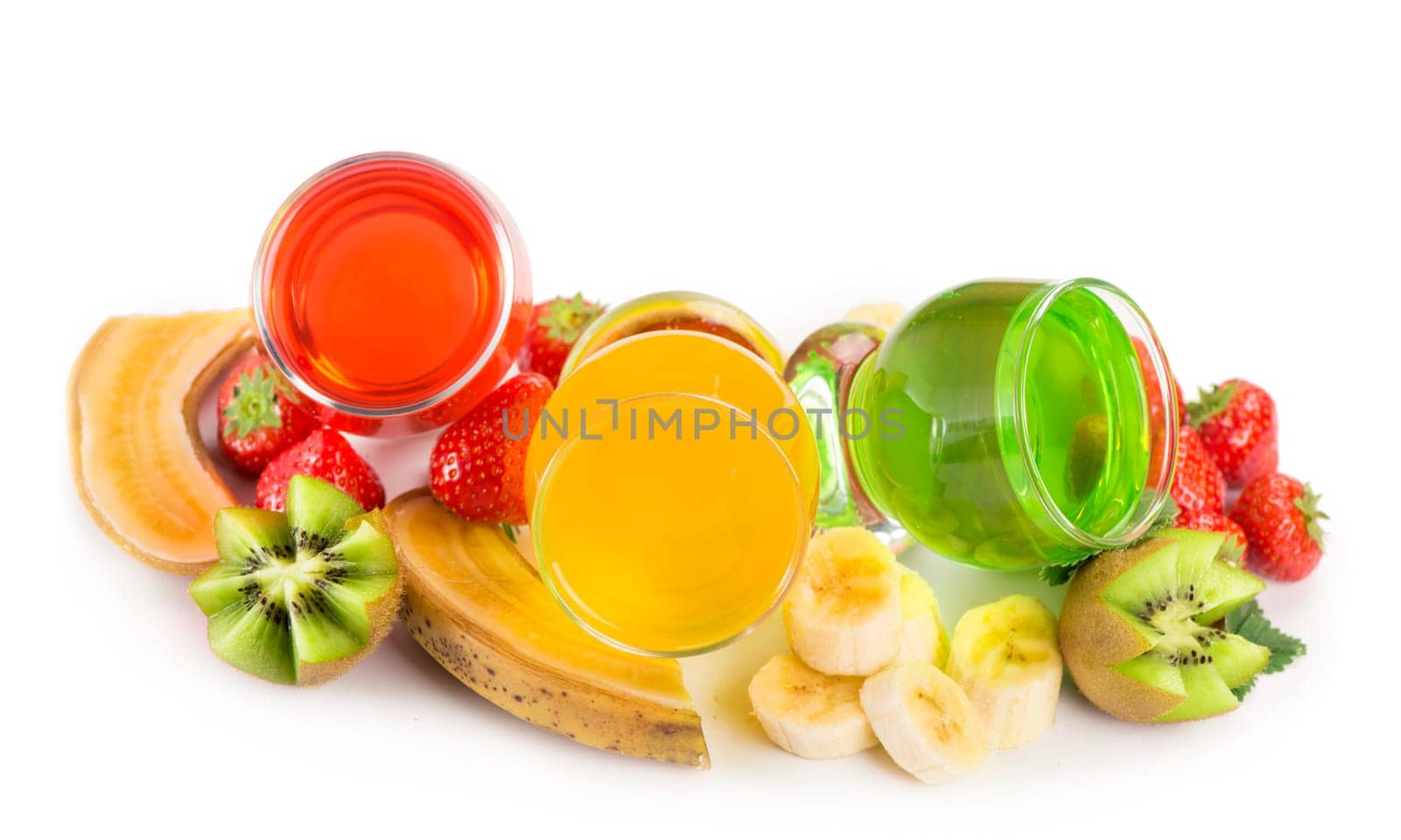 banana , kiwi and strawberry jelly in glasses with fresh berries and fruits on a white background by aprilphoto