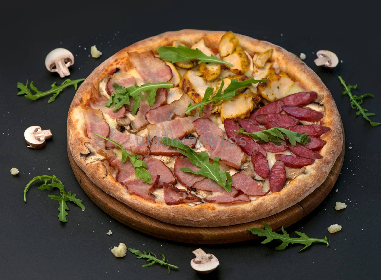Traditional Italian pizza with ham, cheese and arugula on a dark background by aprilphoto