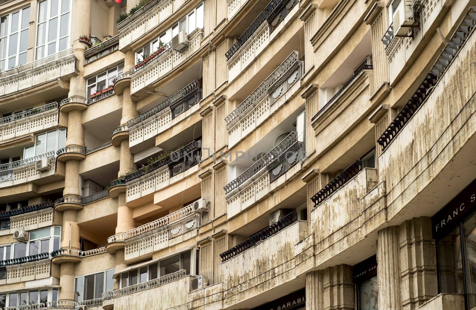 houses balconies of bucharest street. Close up detail with a old built apartment building in Bucharest, Romania by aprilphoto