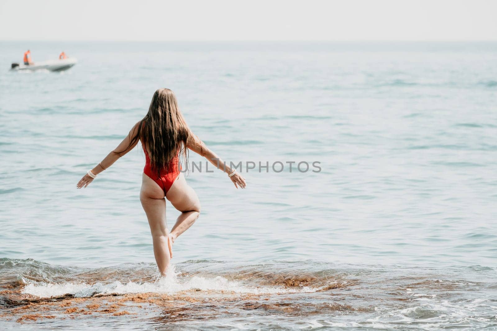 Woman sea yoga. Back view of free calm happy satisfied woman with long hair standing on top rock with yoga position against of sky by the sea. Healthy lifestyle outdoors in nature, fitness concept.