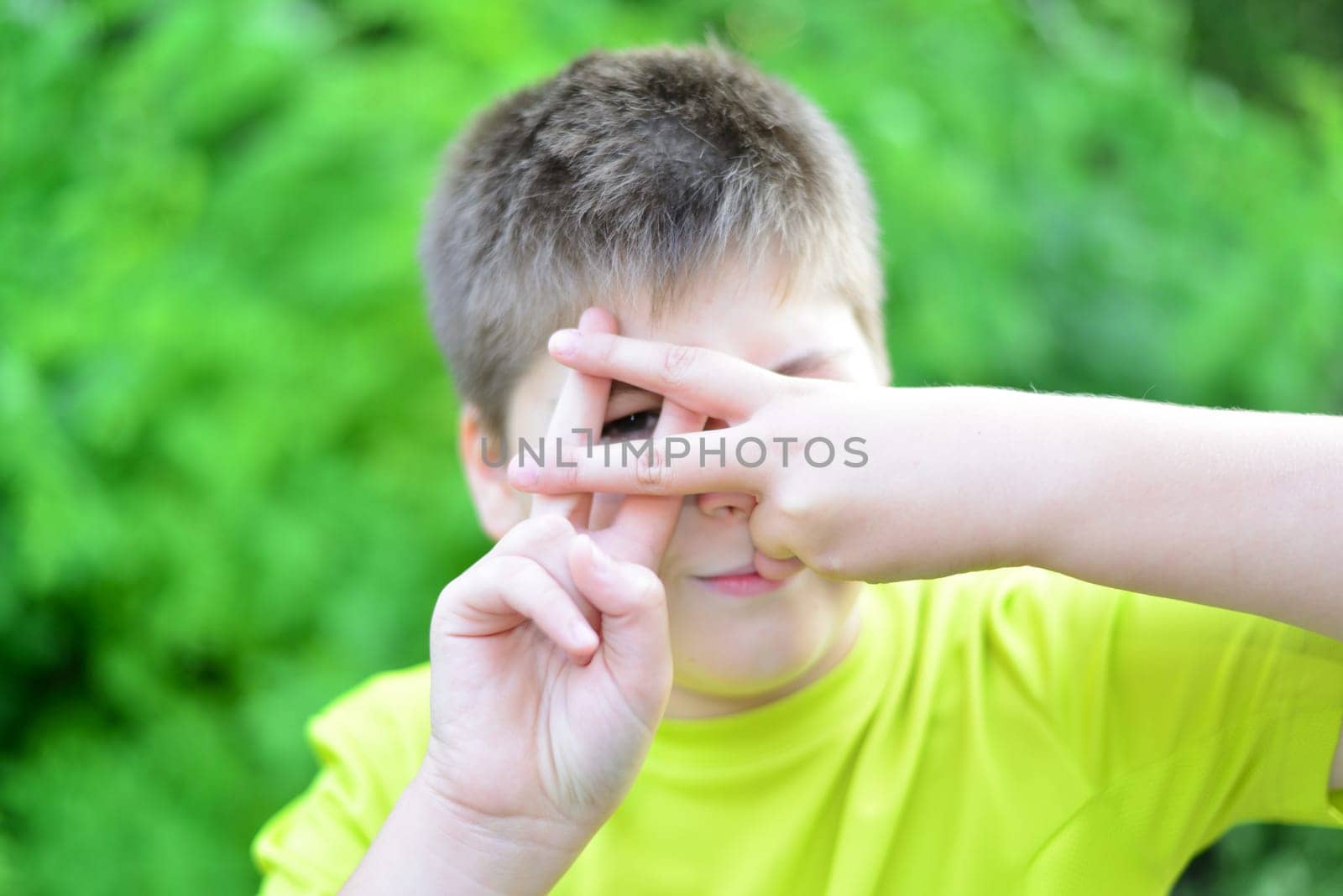 A Boy shows sign gesture prison bars