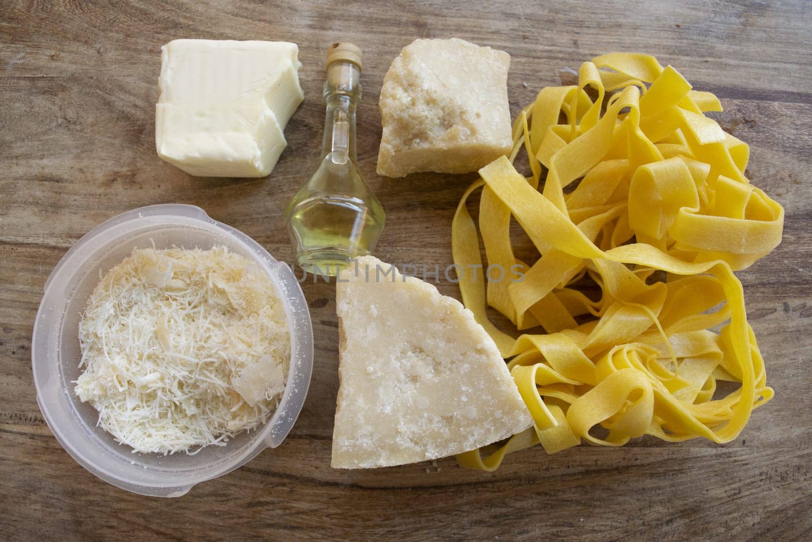 ingredients to making  fettuccine Alfredo with butter parmesan cheese and olive oil