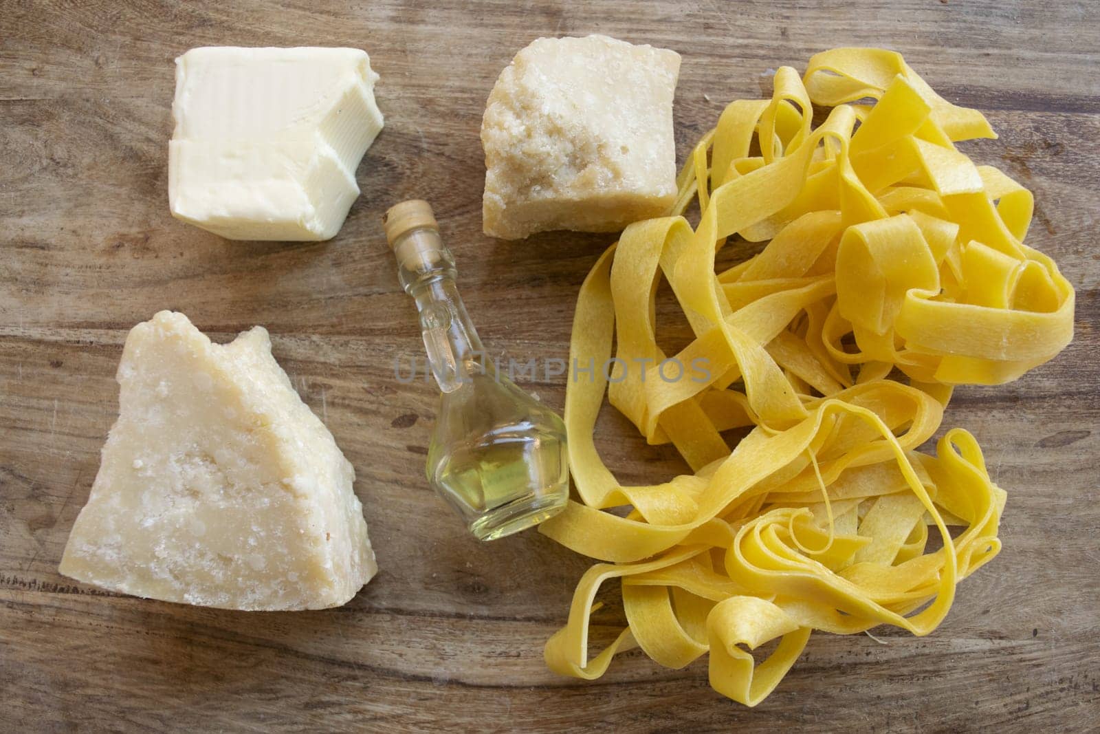 ingredients to making  fettuccine Alfredo with butter parmesan cheese and olive oil