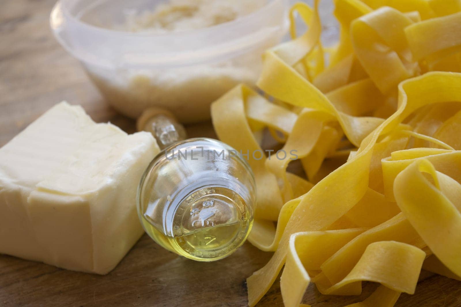 ingredients to making  fettuccine Alfredo with butter parmesan cheese and olive oil