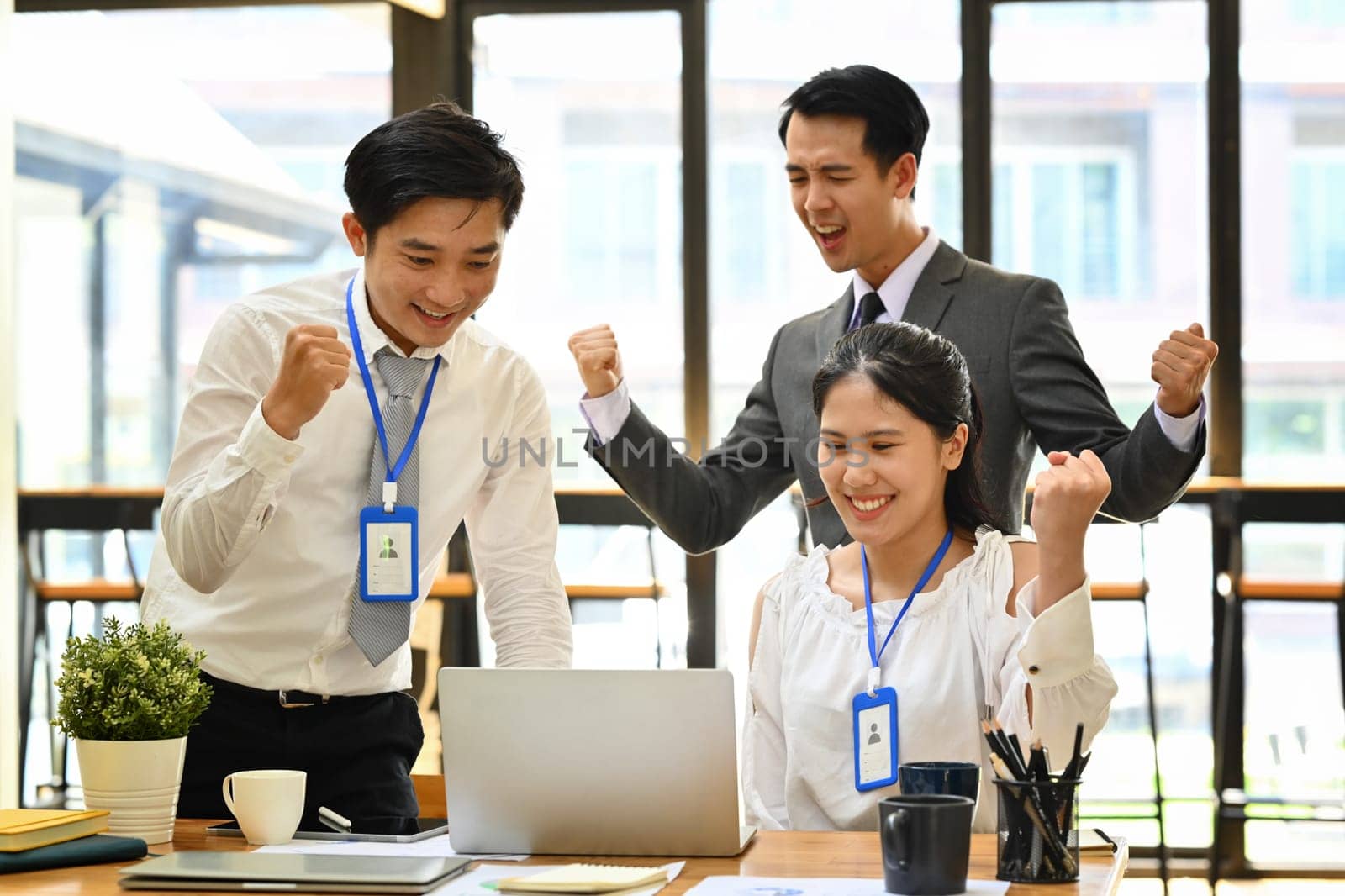 Happy employees team celebrating at the meeting room. Business, teamwork, success and winning concept concept.