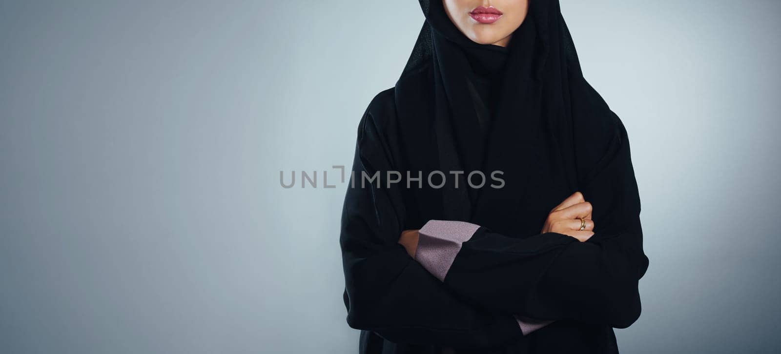 Facing her faith with pride. Studio shot of a young muslim businesswoman against a grey background