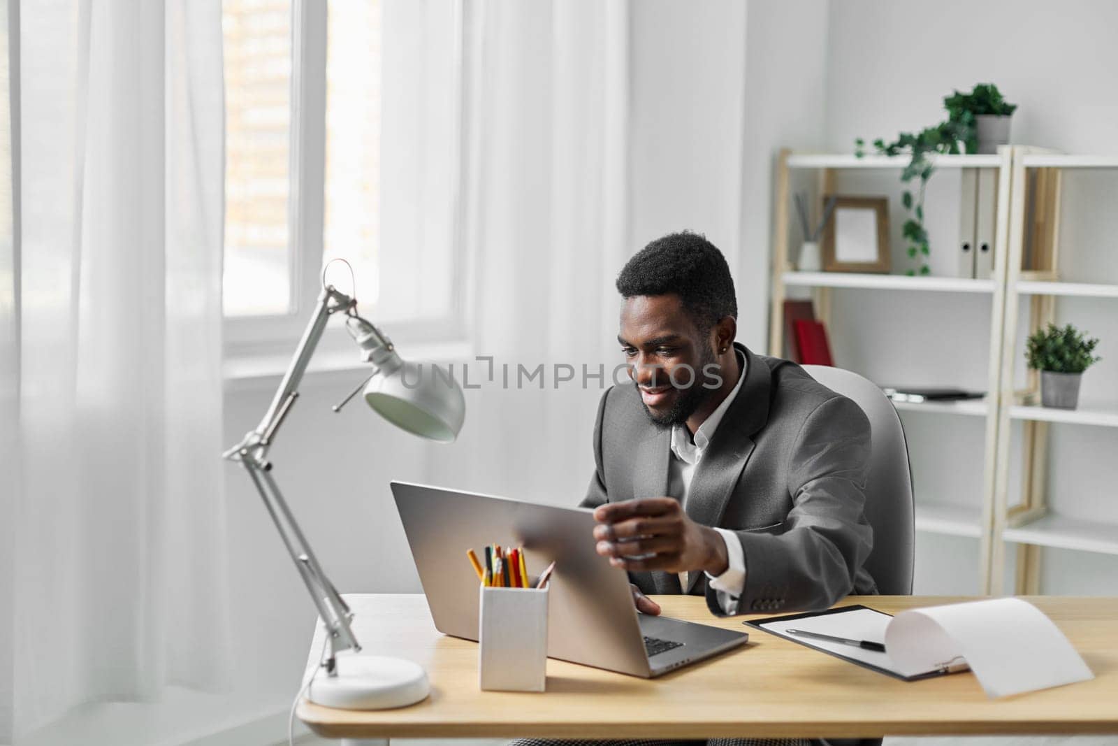 man student laptop online computer job internet education office freelancer african american by SHOTPRIME