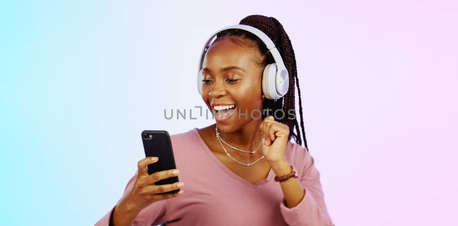 Dance, music and headphones with black woman and phone in studio for freedom, streaming and online radio. Happiness, technology and relax with girl dancing to track, songs and audio on background.