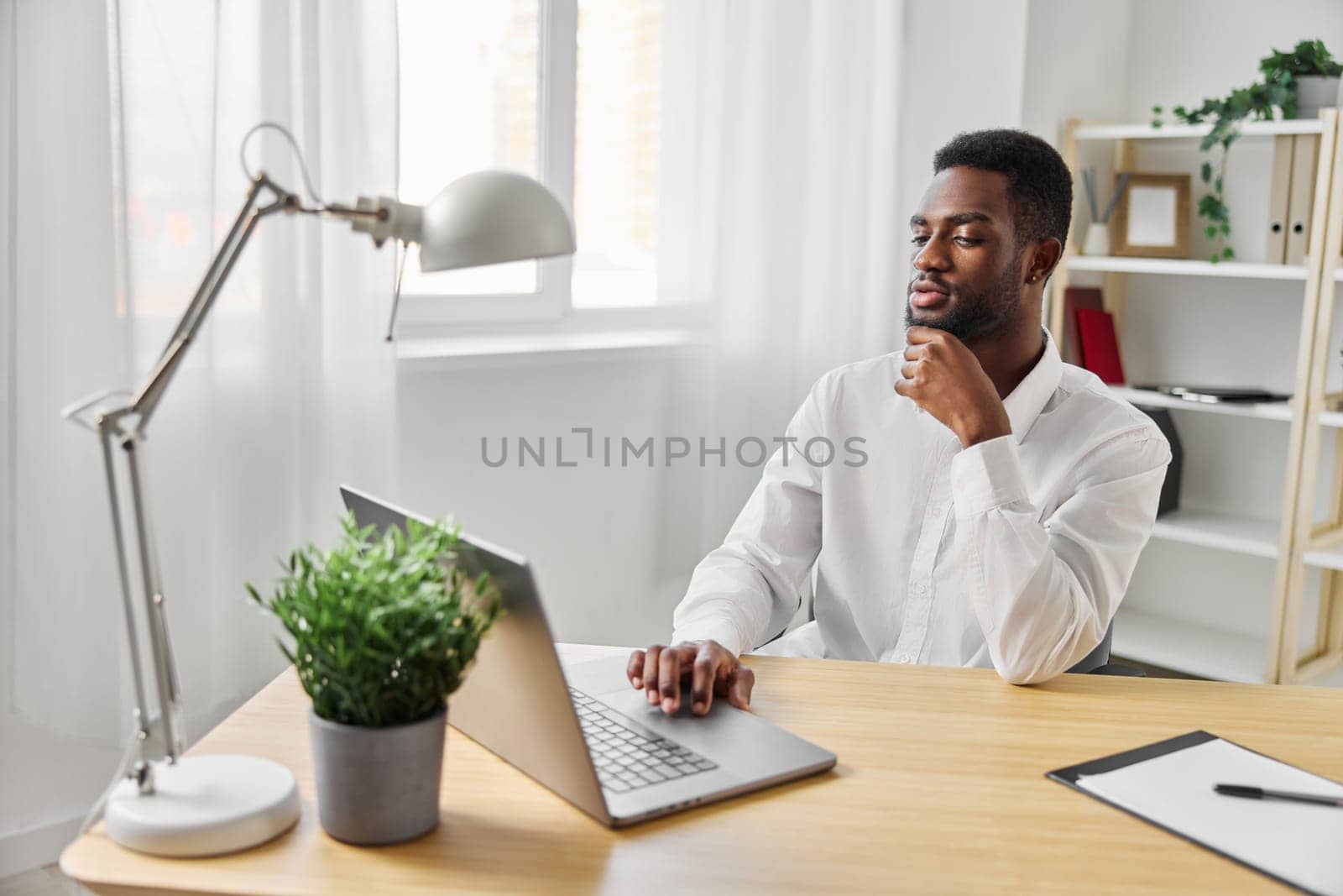 man laptop chat computer online freelancer education office american african job student by SHOTPRIME
