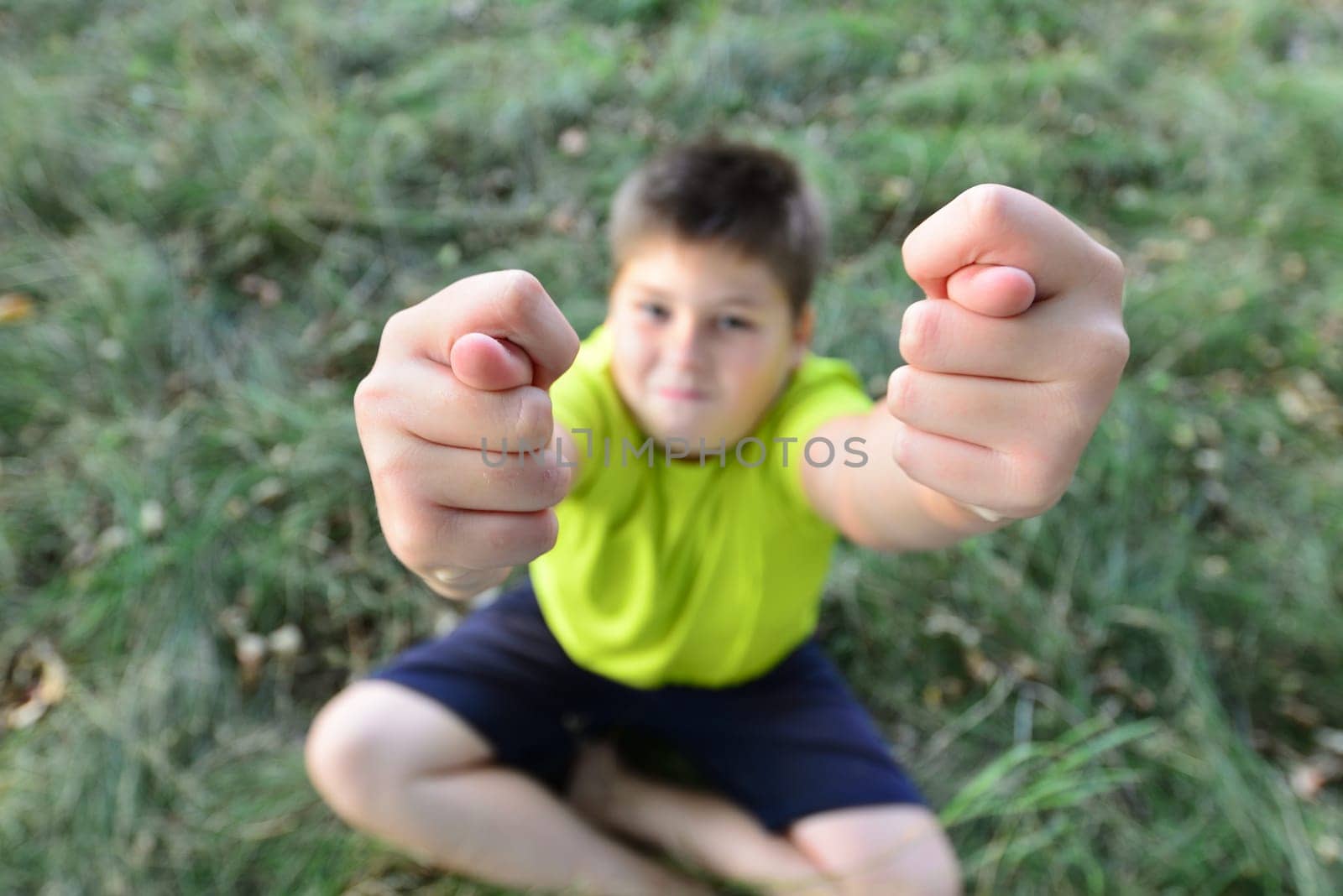 Teen boy shows the hand gesture.