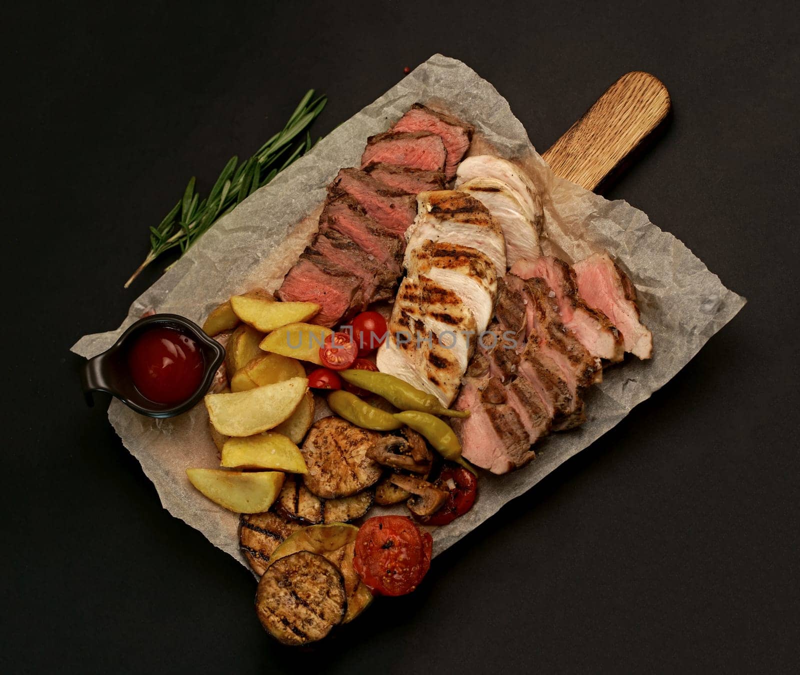 grilled meat. several types of grilled meat cut on a wooden board by aprilphoto