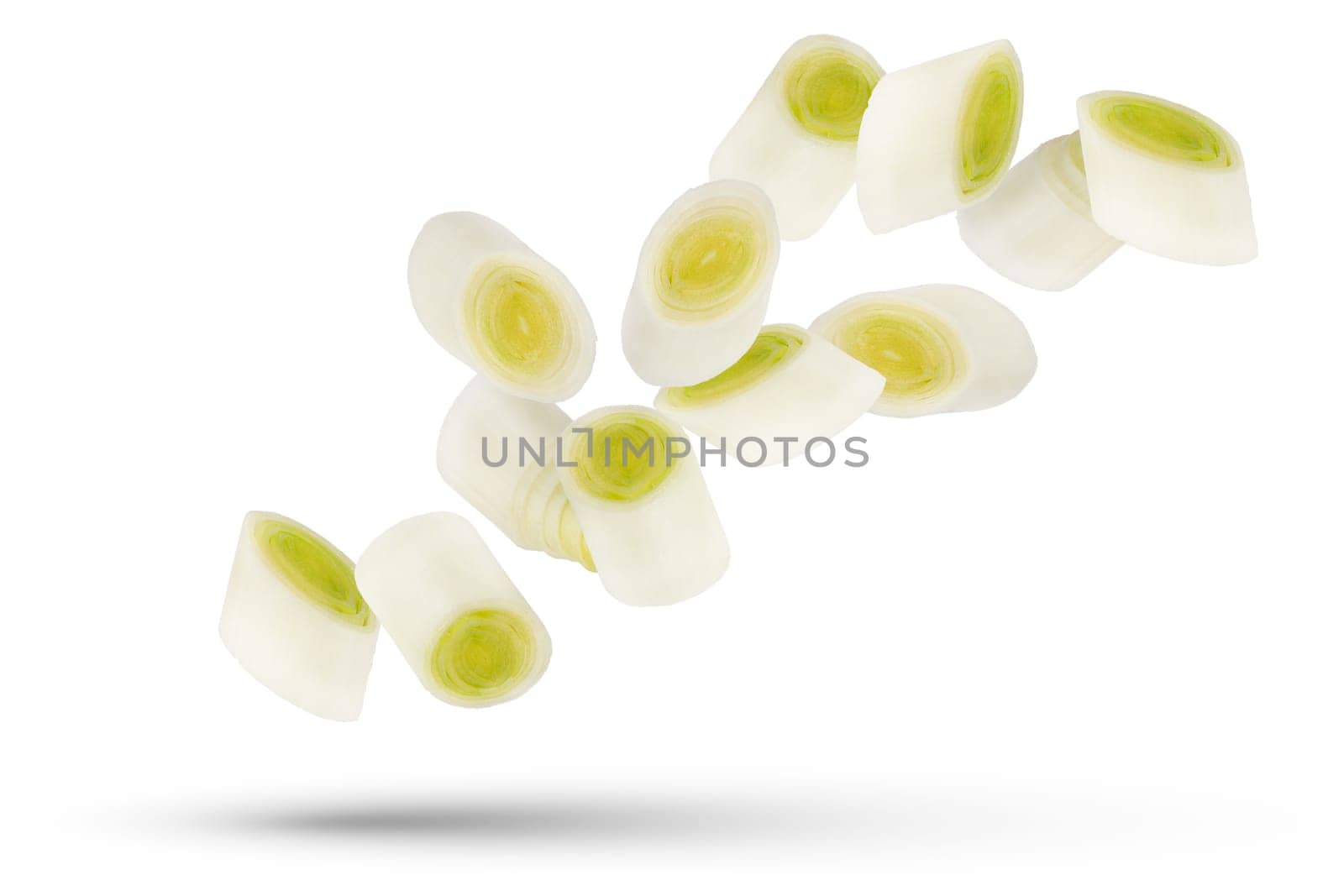Leek slices. White and green onion slices isolated on white background. A group of leek slices of different sizes and shapes scatter in different directions. High quality photo