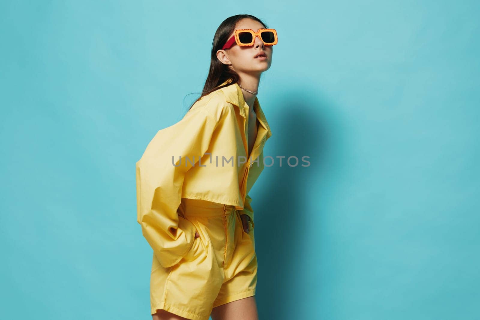 blue: woman hairstyle background beautiful funny trendy sunglasses fashion yellow attractive young stylish expression brunette lifestyle girl lady beauty romance outfit pretty