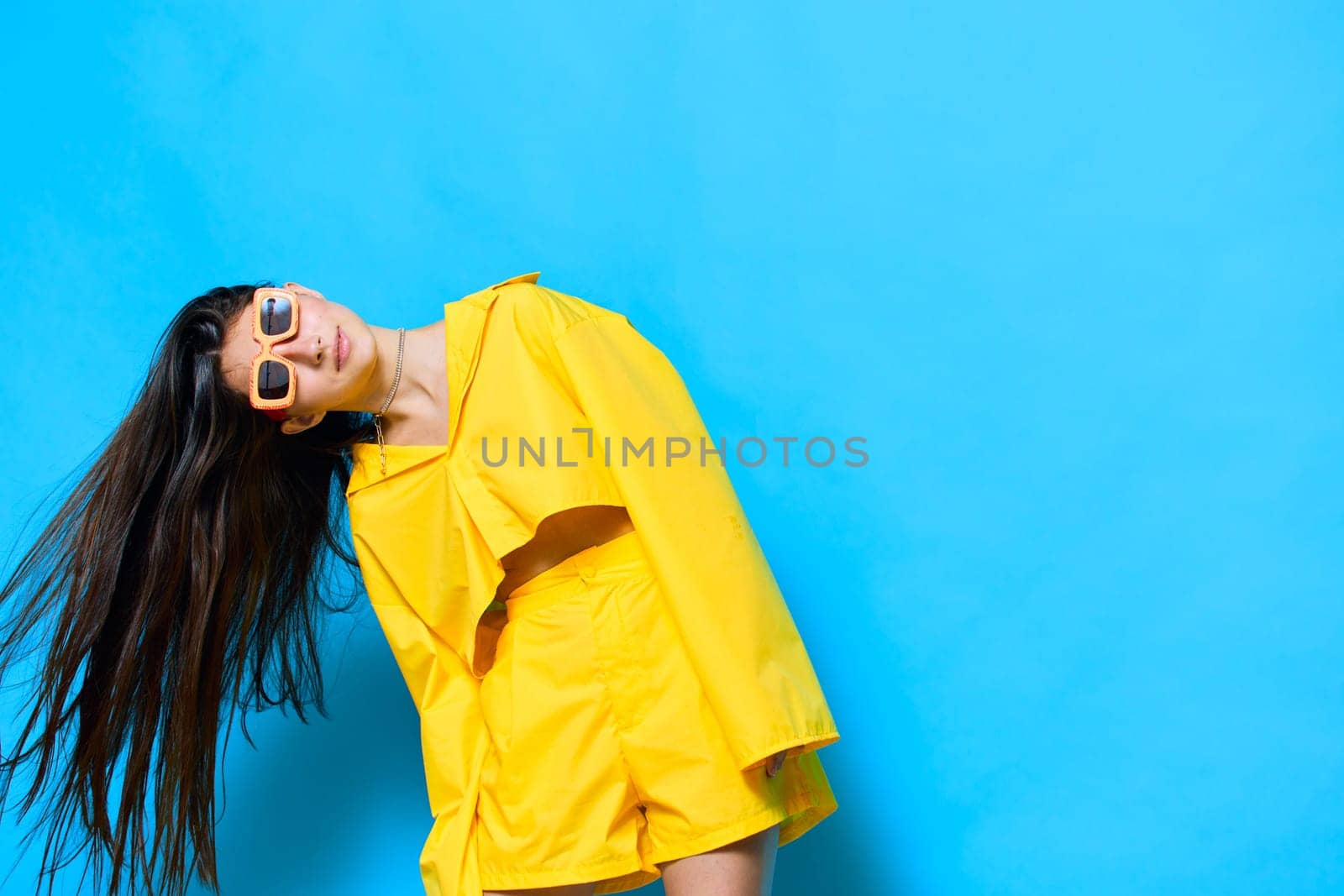 fashion woman romance caucasian sunglasses dance outfit trendy beautiful emotion funny cheerful attractive blue: yellow female lifestyle model girl hairstyle glasses young