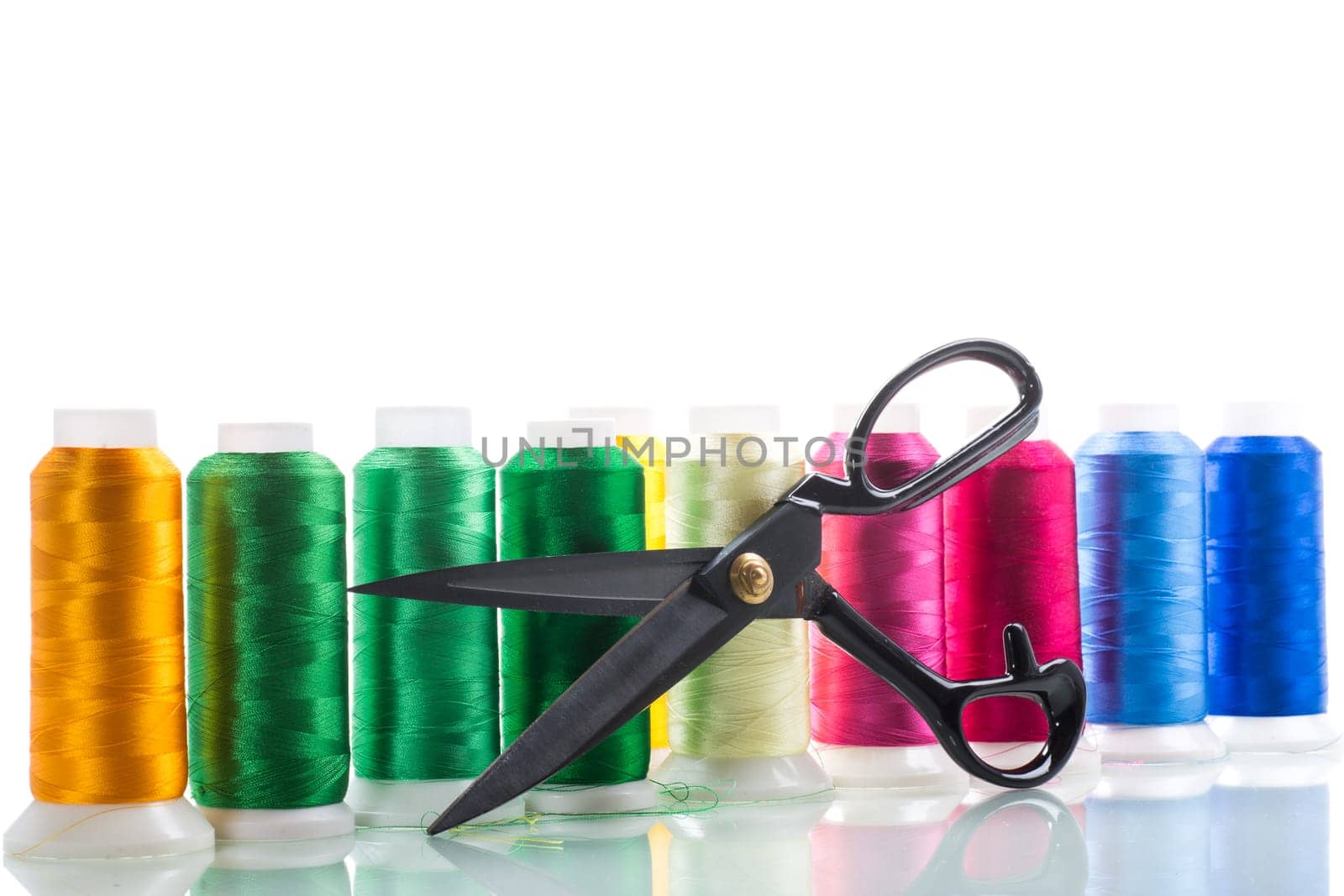 set of different color sewing threads,on white background. by Rawlik