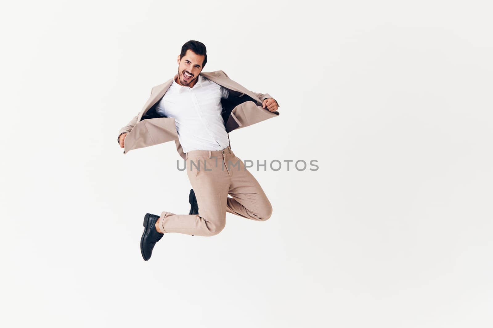 man beige confident running sexy smiling professional suit job victory business happy flying adult attractive jumping winner isolated businessman standing office