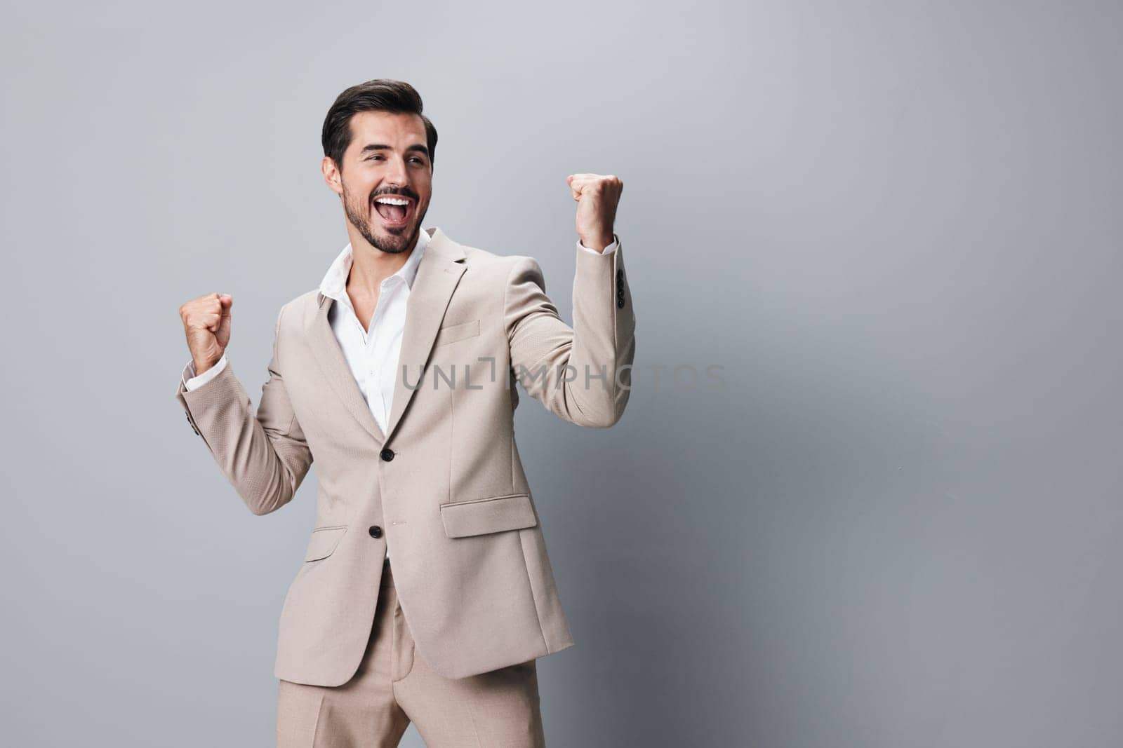 person man victory businessman happy arm portrait background model suit business winner beige smile up celebrate occupation isolated sexy posing hand