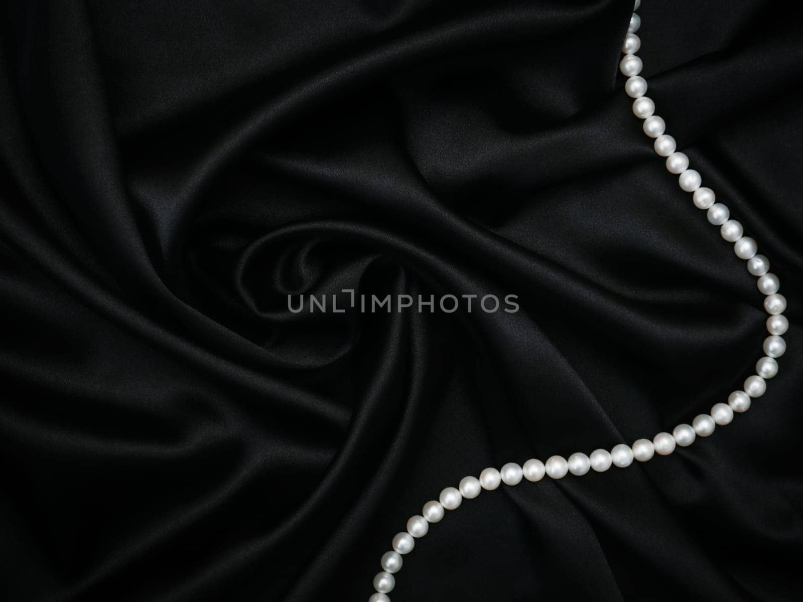 Beautiful set of women's evening accessories. Pearl neck and silk black dress. Elegant classic female jewel. Decoration design. Soft focus. Luxury and sexy concept. Party time by Halina