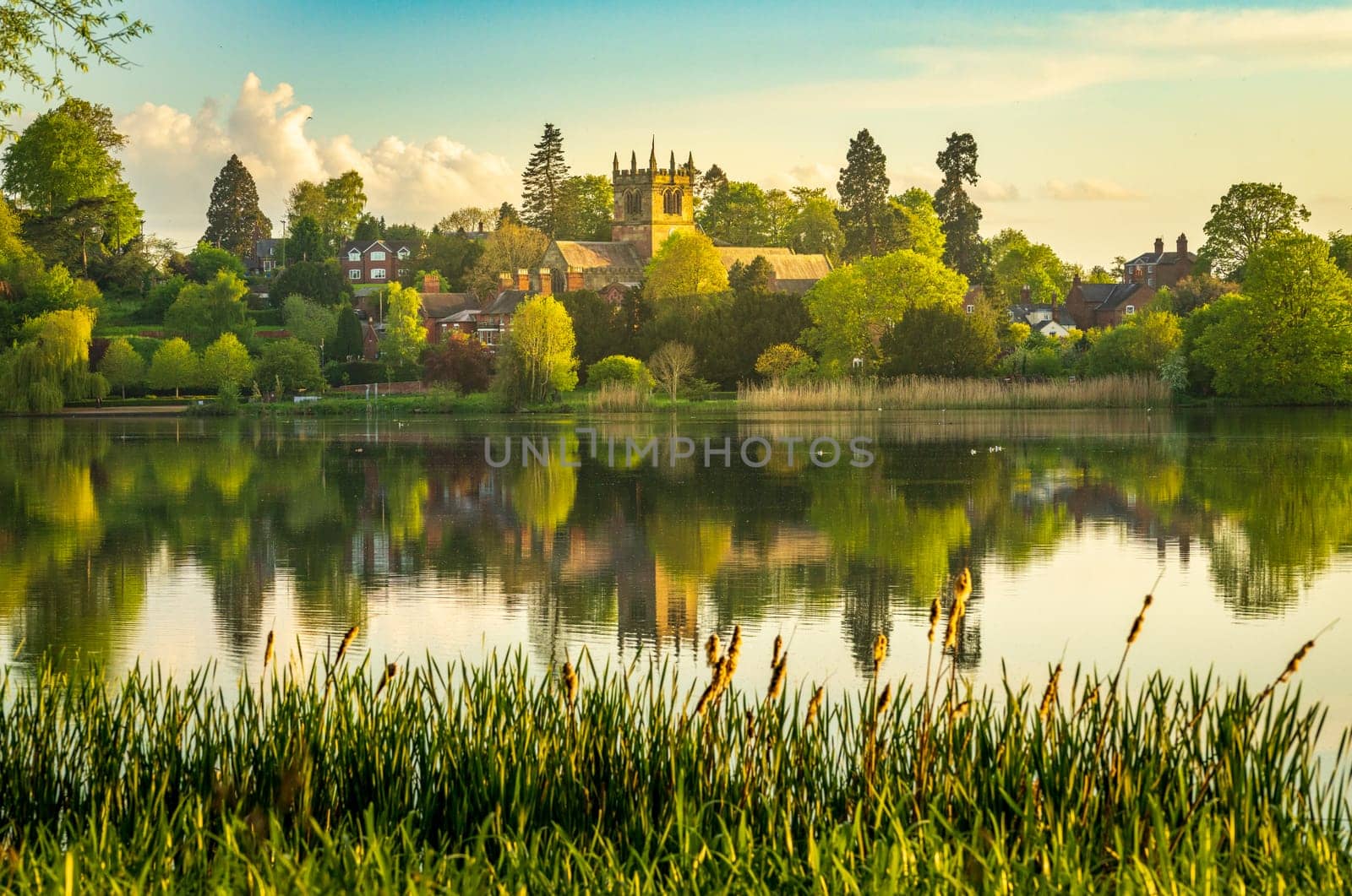 Town of Ellesmere in Shropshire with reflection view from across the Mere to the Church