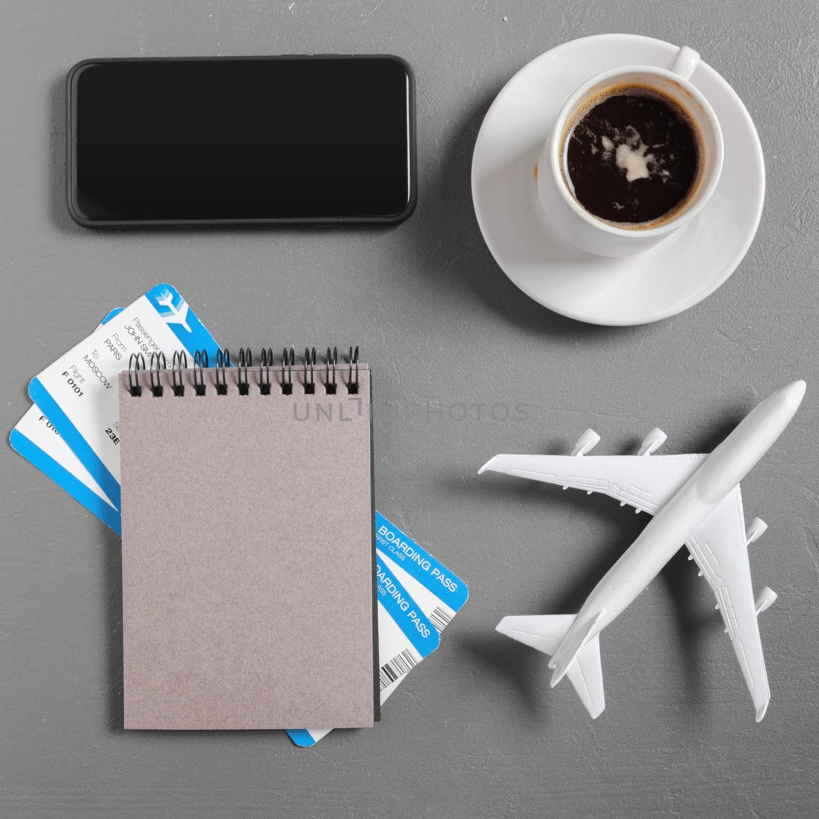 boarding pass and toy airplane on table top view by Fabrikasimf