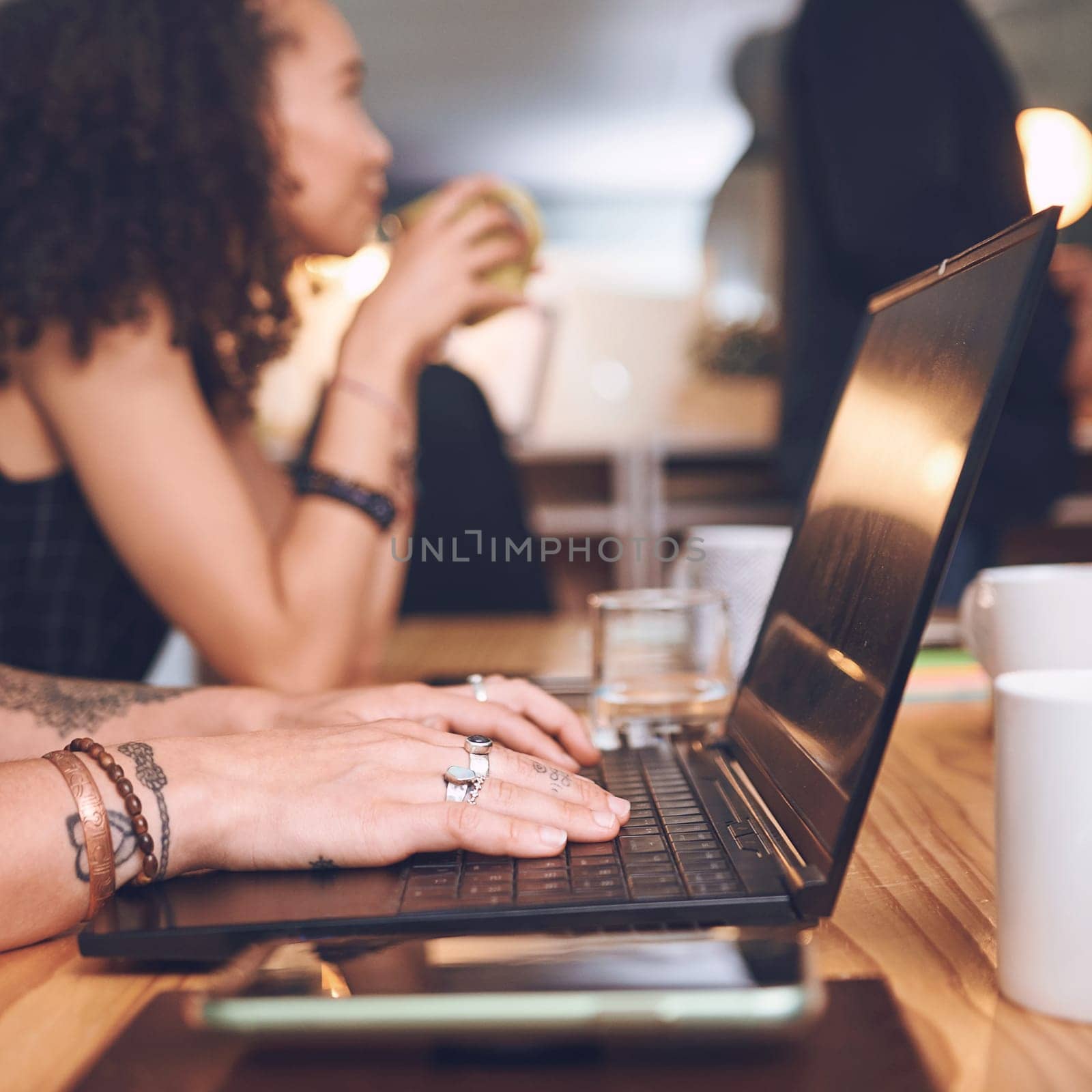 Less paper, more data processing. an unrecognisable businesswoman using a laptop during a meeting in the boardroom of a modern office