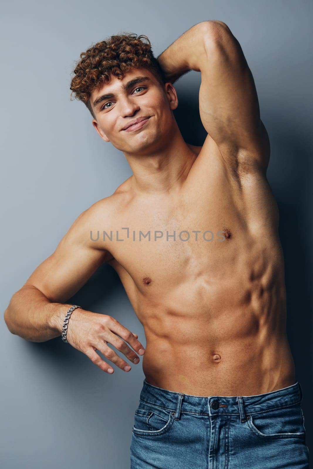 man standing sport bicep muscular handsome chest naked person strong jeans torso young by SHOTPRIME