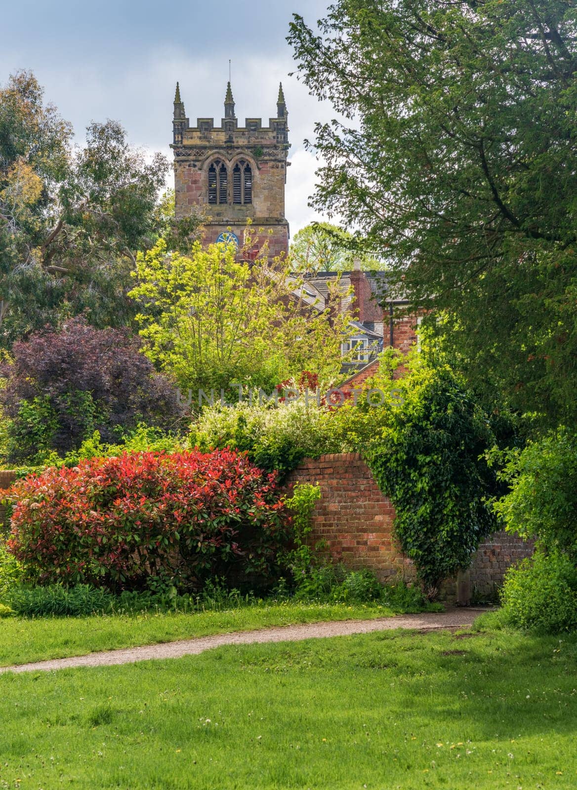 Church tower of parish church of St Mary in Ellesmere Shropshire from gardens