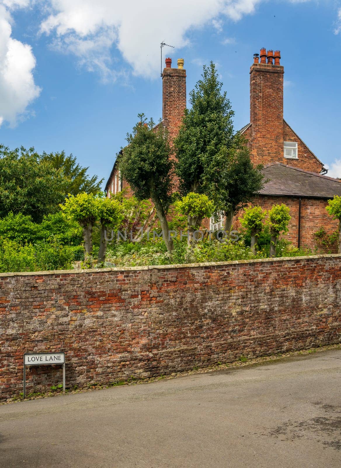 Old brick georgian home behind garden wall on Love Lane Ellesmere Shropshire