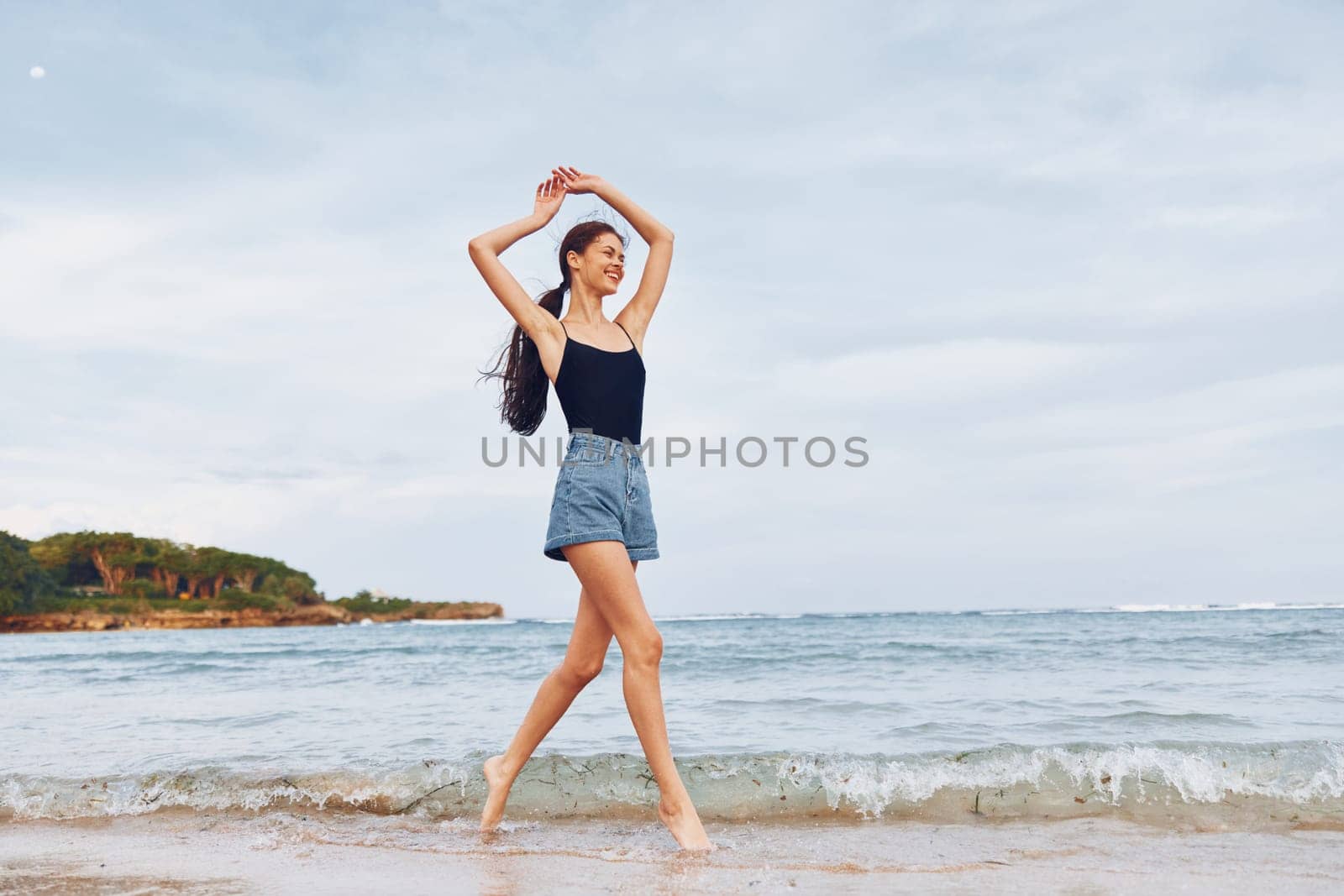 woman leisure travel summer smile young long sea hair sunset active positive body beach water walking shore person lifestyle running flight hair