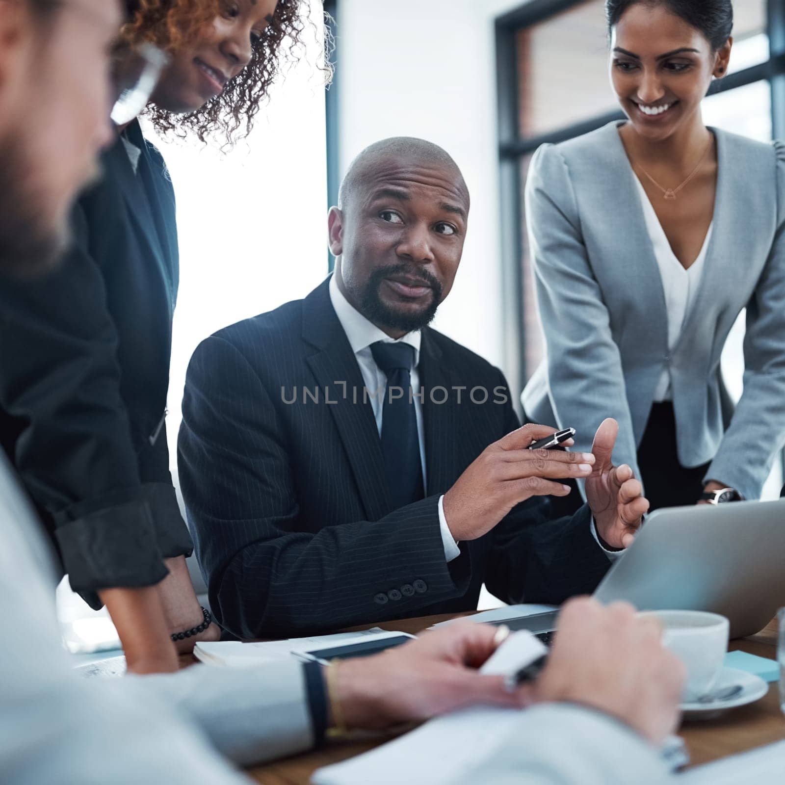 This is going to be a difficult one...a group of businesspeople discussing something on a laptop