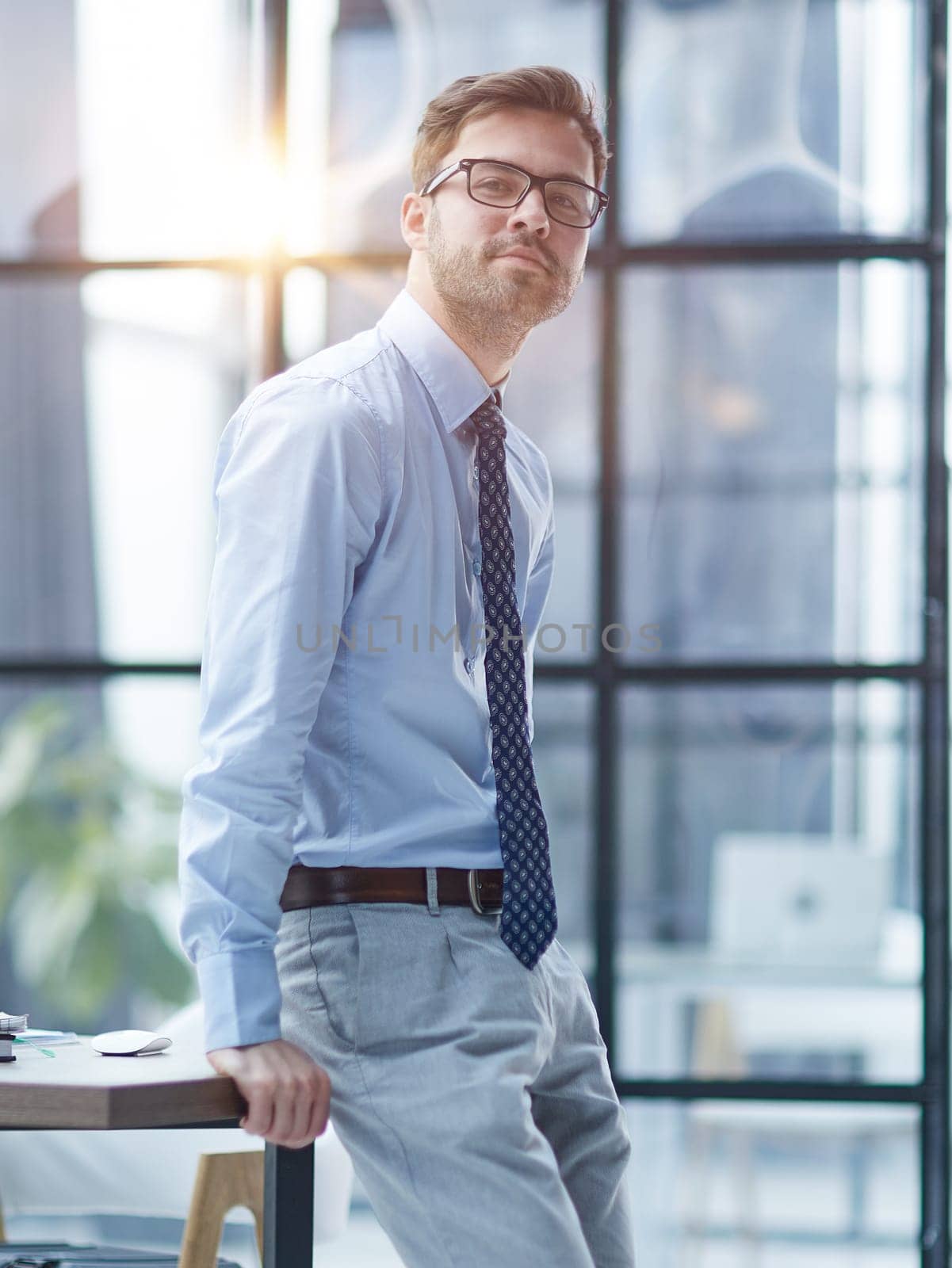 Young cheerful businessman working at office
