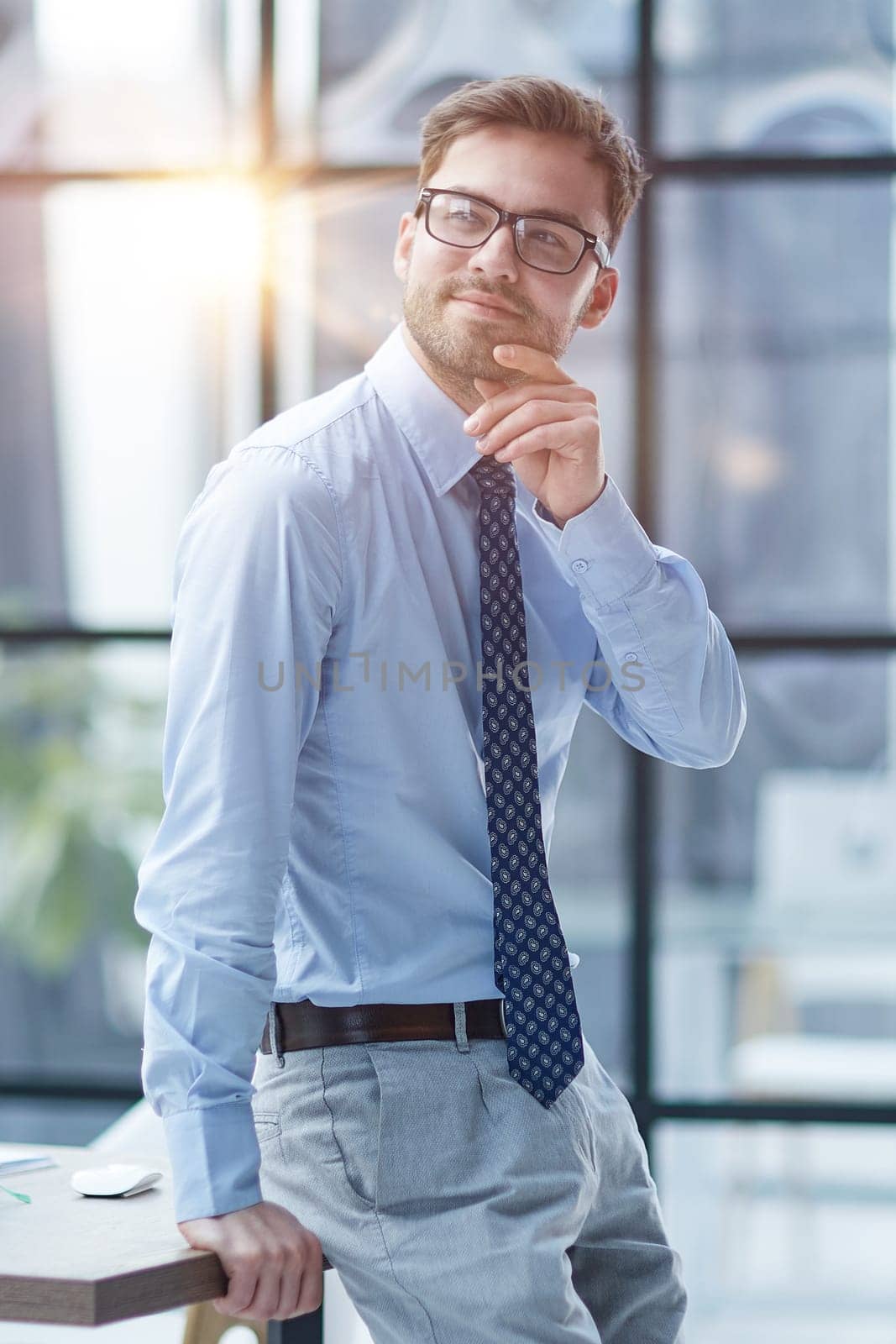 Young cheerful businessman working at office