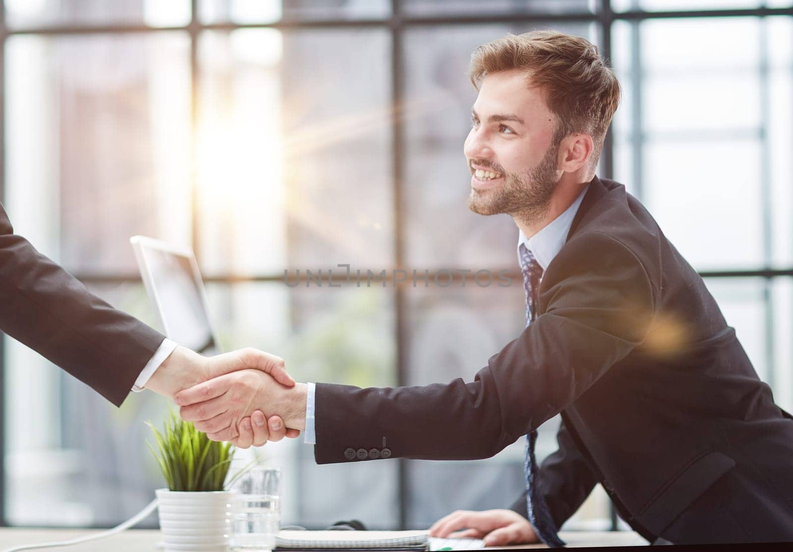 Portrait of cheerful young manager handshake with colleague by Prosto