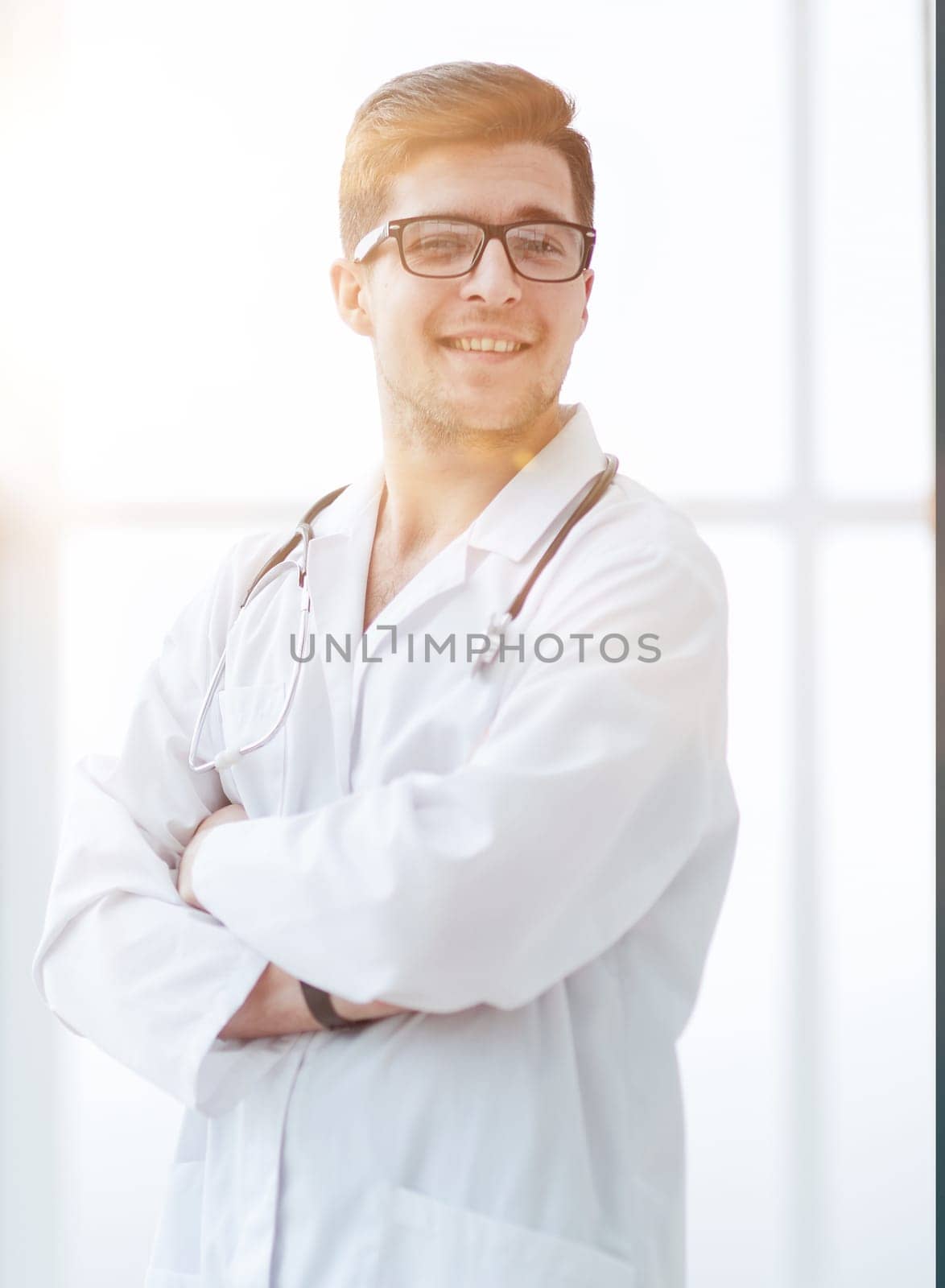 Portrait of young, doctor sitting in medical office
