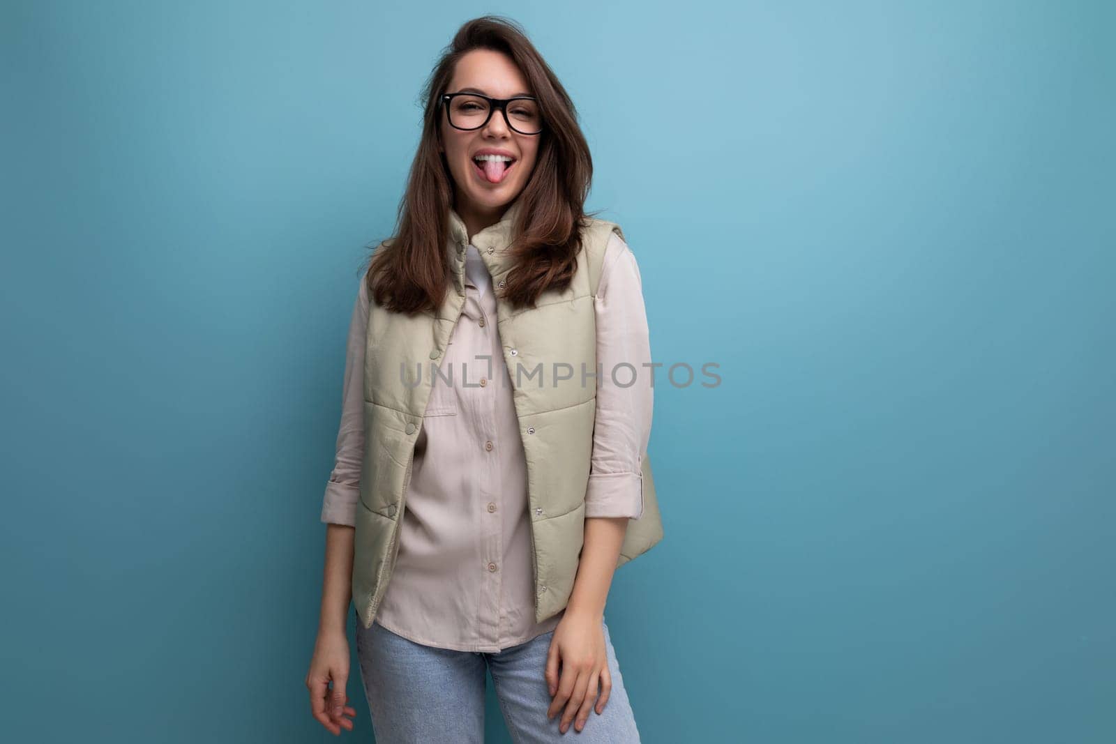 pretty young brunette woman in stylish eyeglasses on studio background with copy space by TRMK