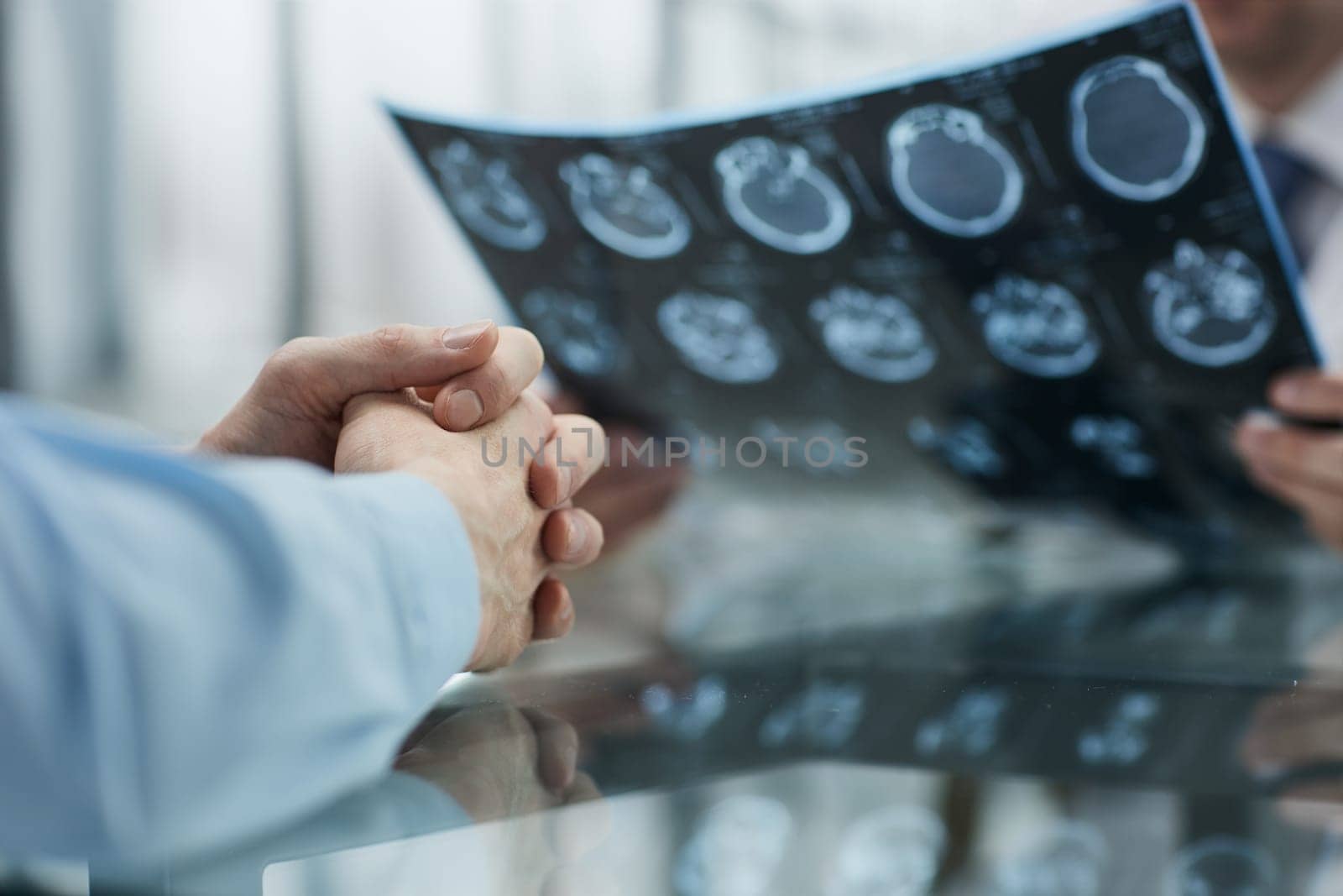 the doctor and the patient at the reception are discussing the x-ray