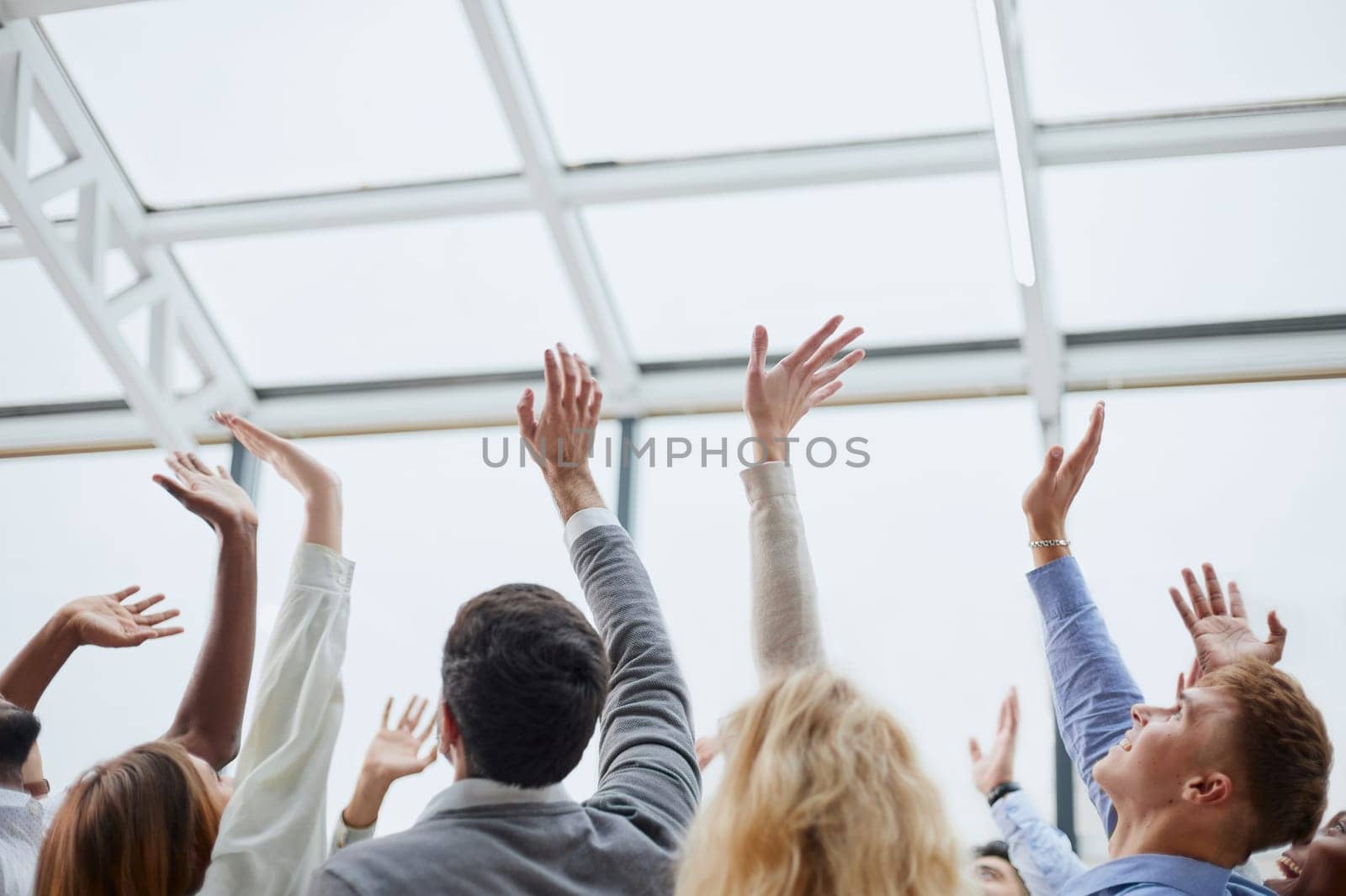 large team of young people pointing somewhere up