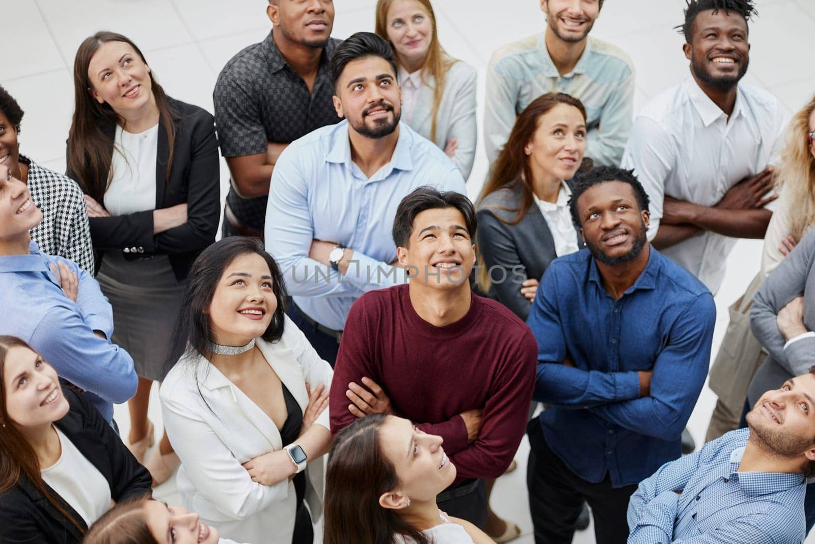 Group of successful business people looking up