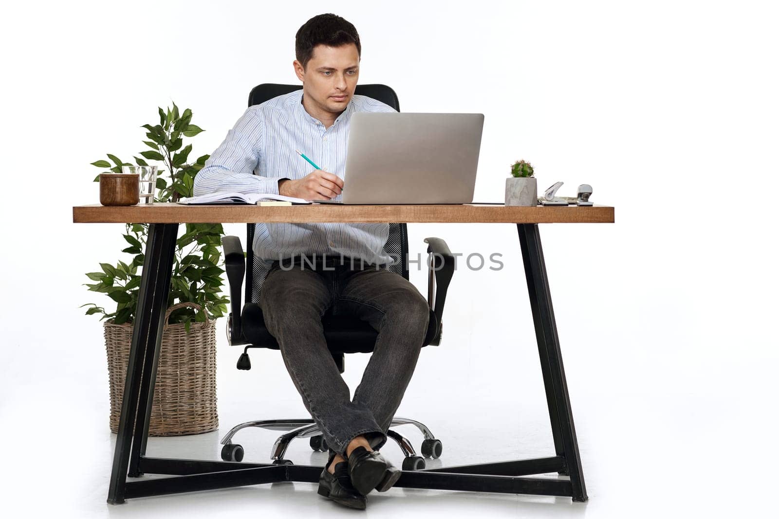entrepreneur man using laptop computer for online work at table on white background