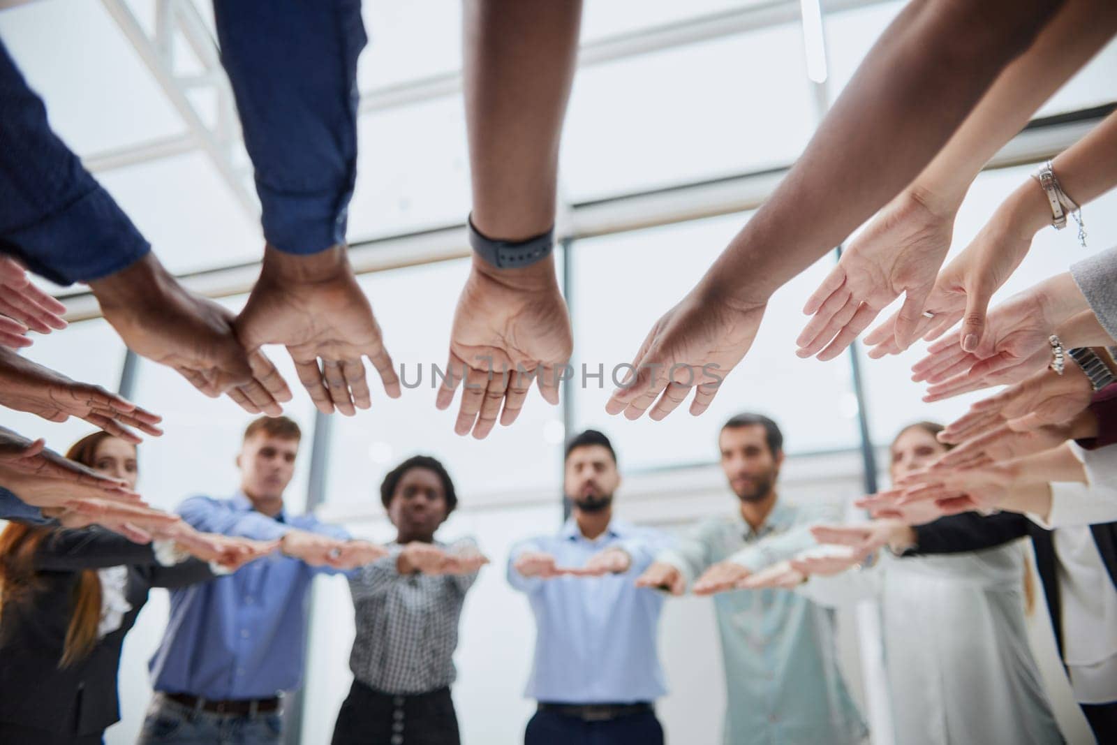 a group of young people stretched out their hands towards by Prosto