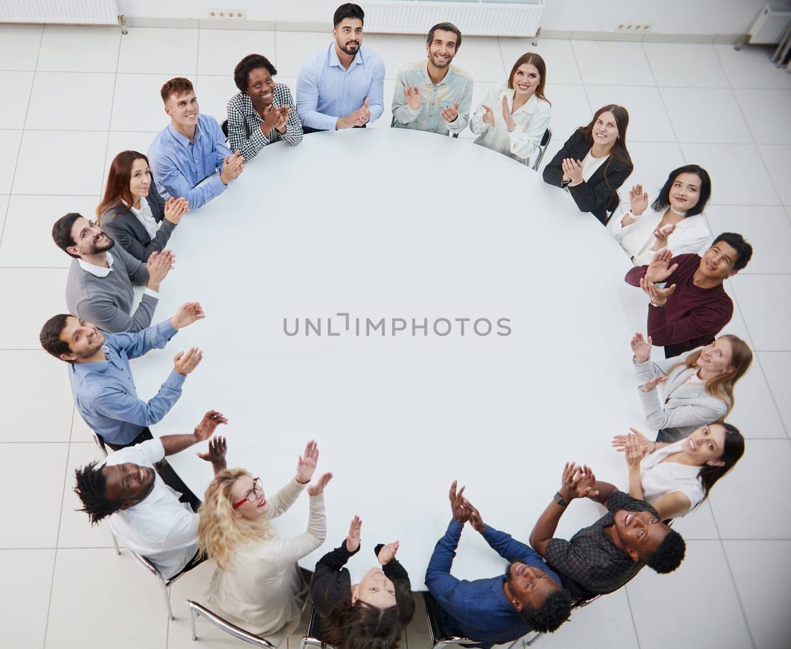 Clerks or colleagues sitting at round table and discussing ideas or brainstorming.