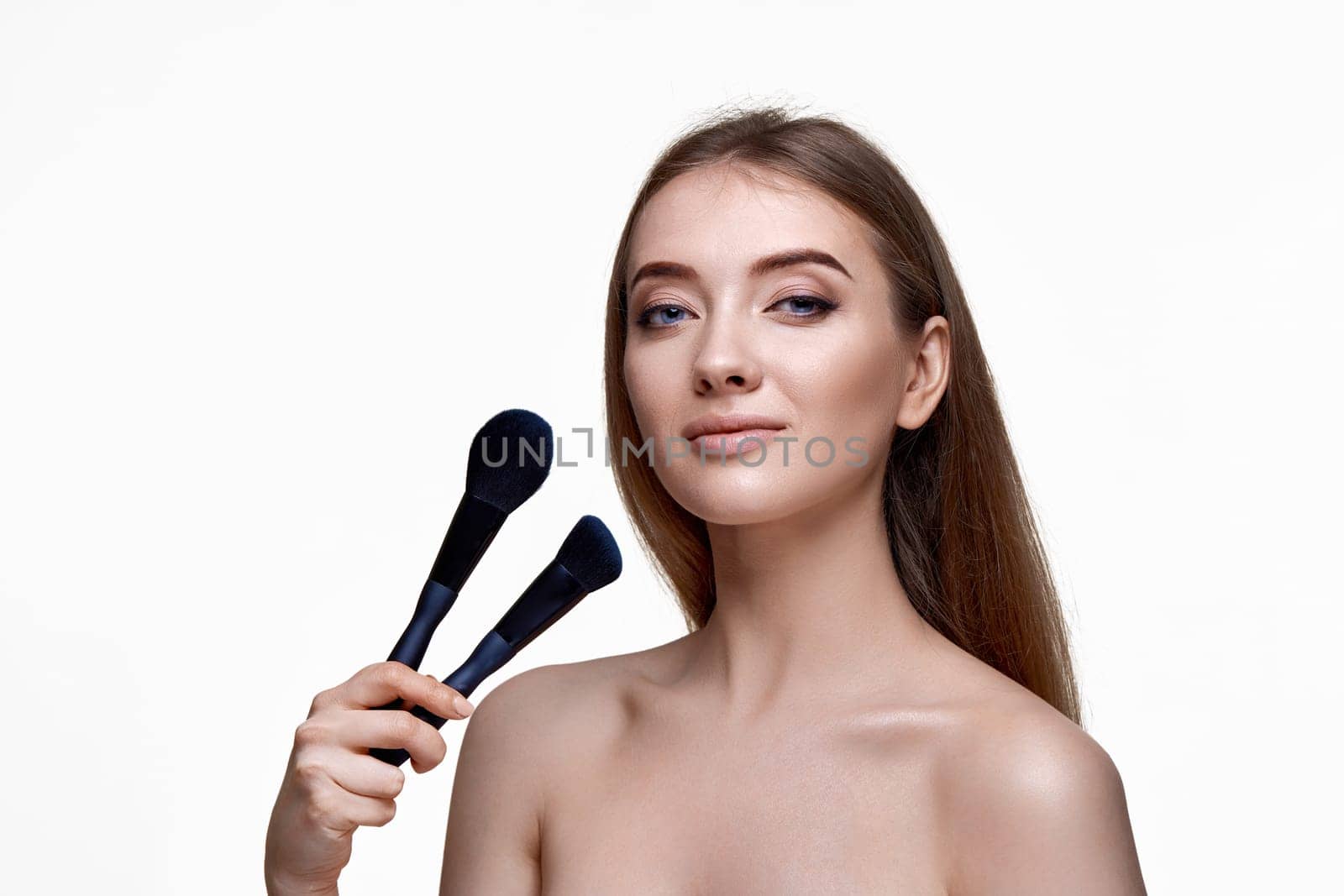 beautiful happy woman with make-up brush for powder isolated on white background. copy space