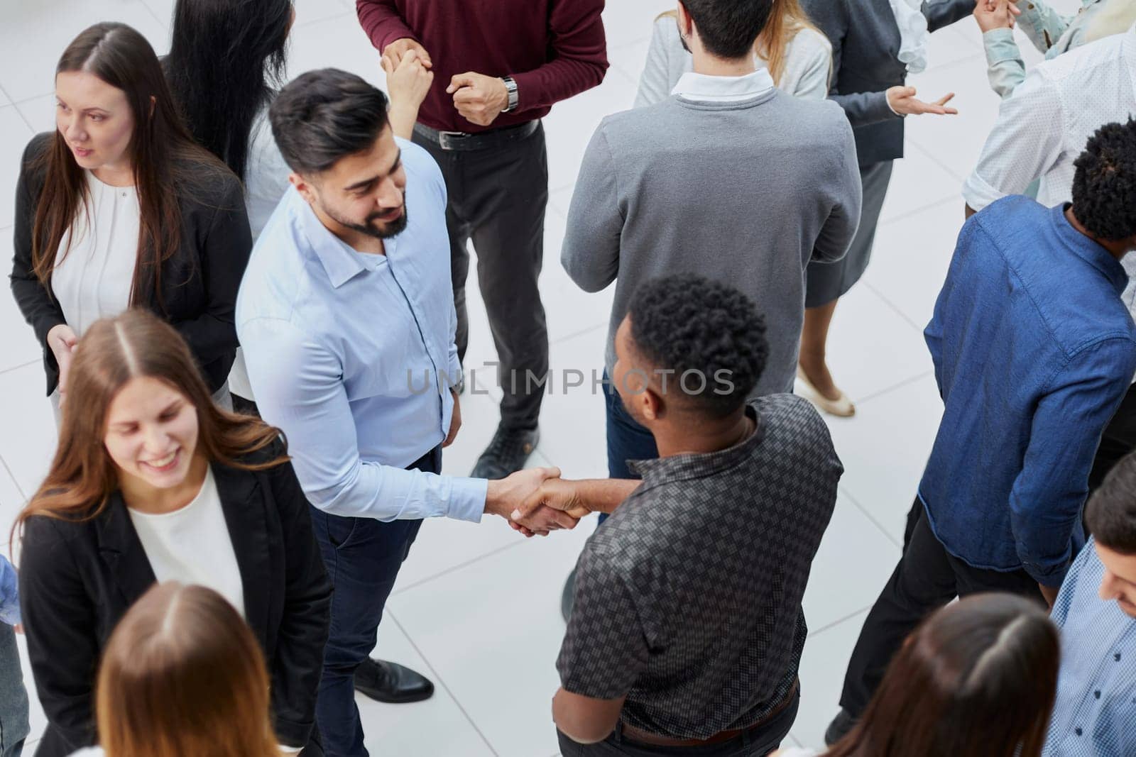 Coworkers having business meeting in a lobby by Prosto