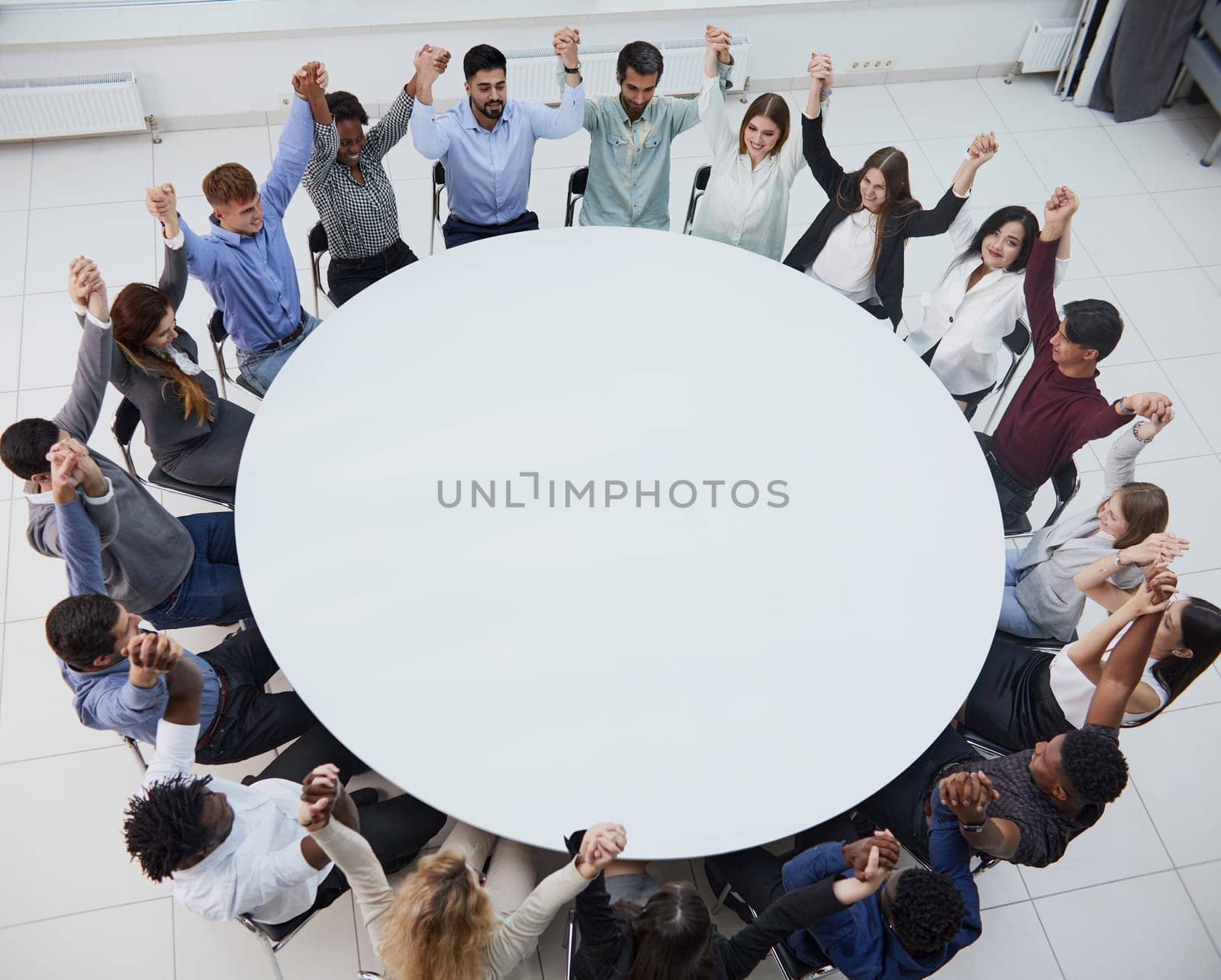 coach leads the session with business team sitting at a round table. by Prosto