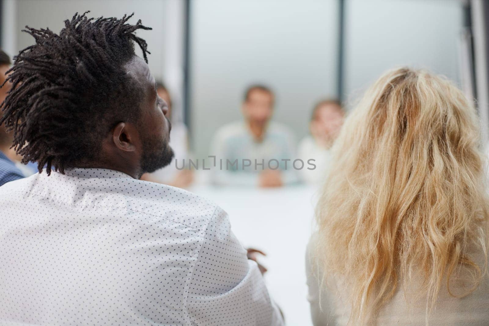 Multicultural businesspeople discussing work sitting at a round table