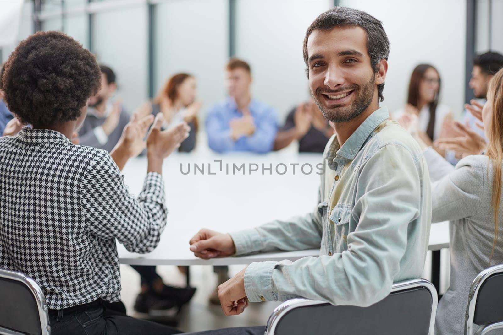 Smiling business group of office workers, executive board members or employees looking at camera