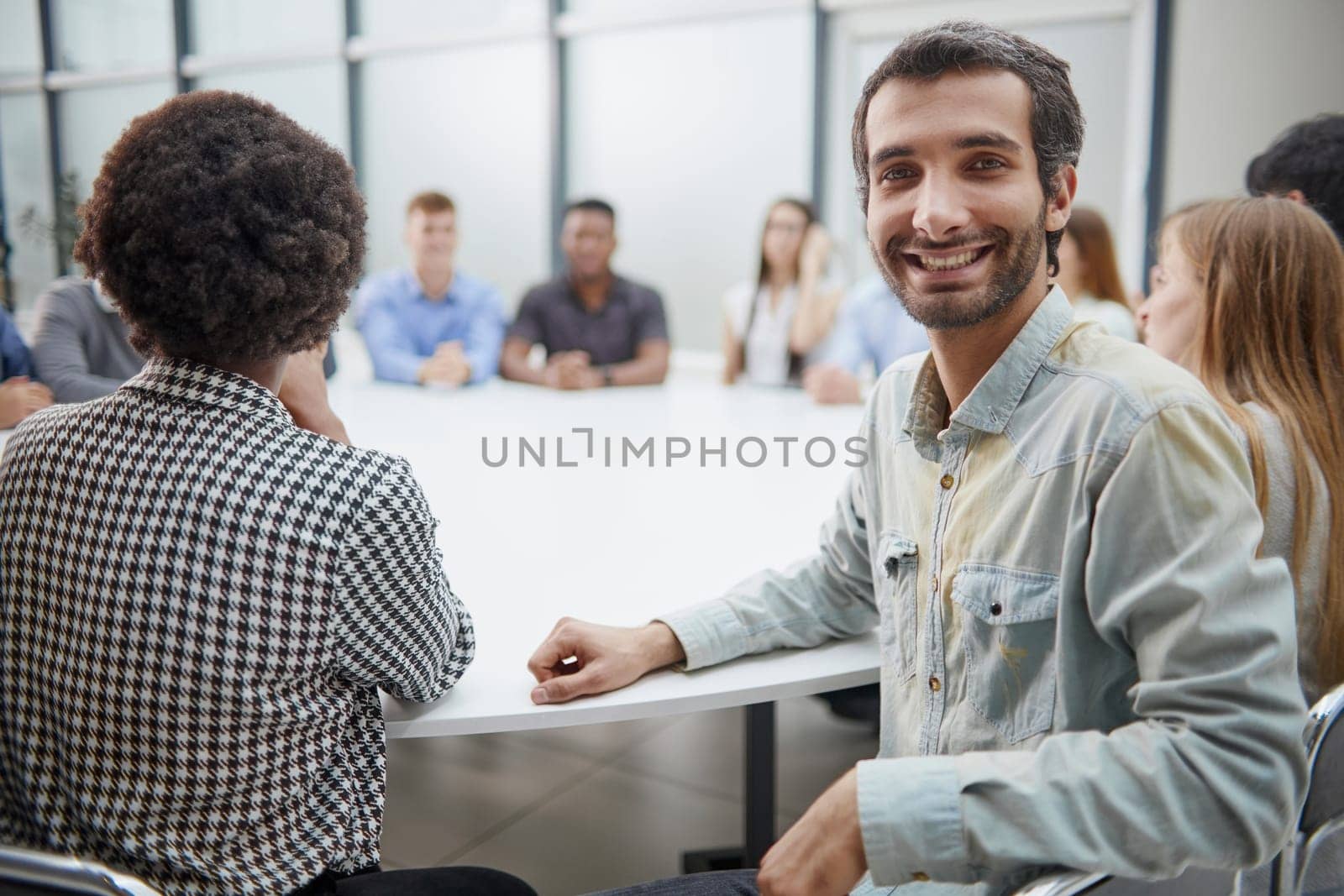 Smiling business group of office workers, executive board members or employees looking at camera