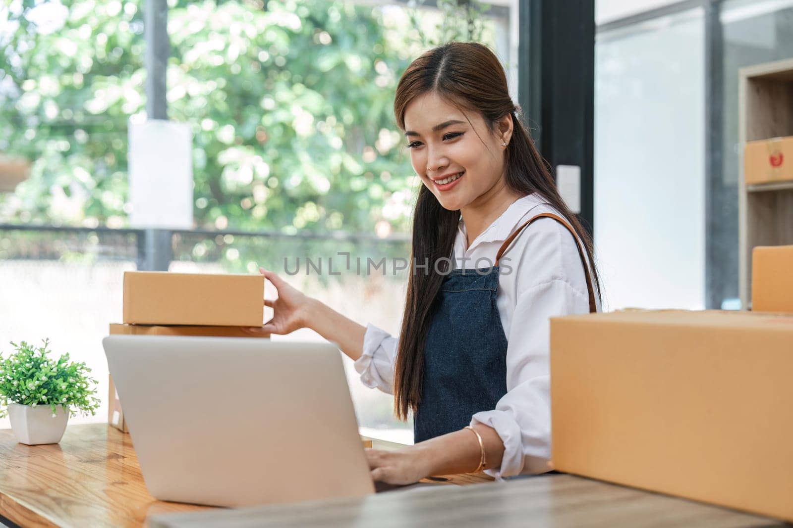 Starting small businesses SME owners female entrepreneurs check online orders to prepare to pack the boxes, sell to customers, business ideas online.